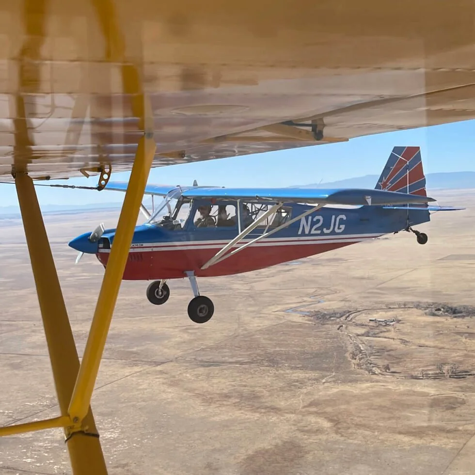 Wetsu Aviation Super Decathlon N2JG in flight taken from Super Cub Back Country Aviation