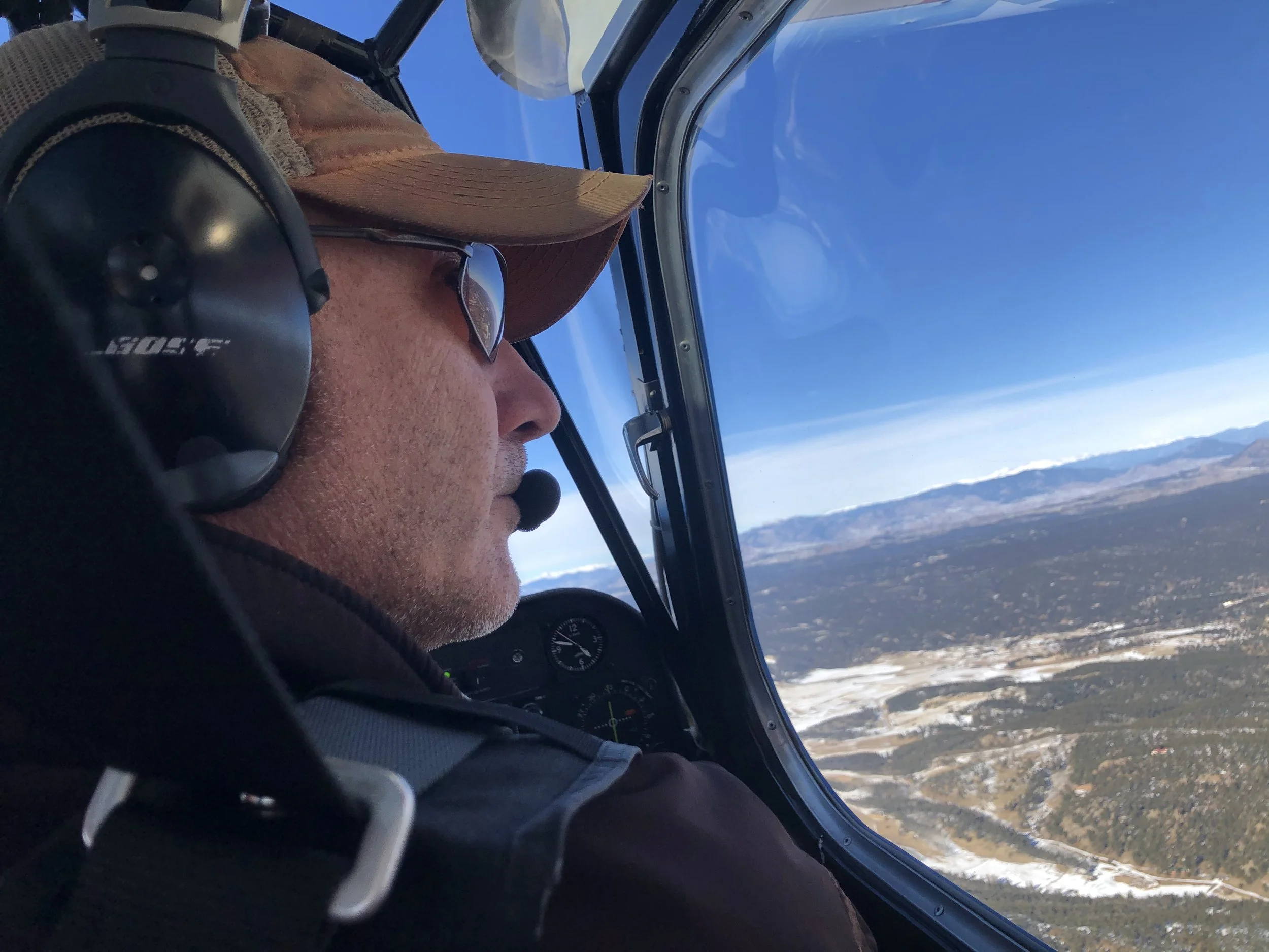 Scott Oatman flying American Champion Super Decathlon N2JG over the Colorado Mountains