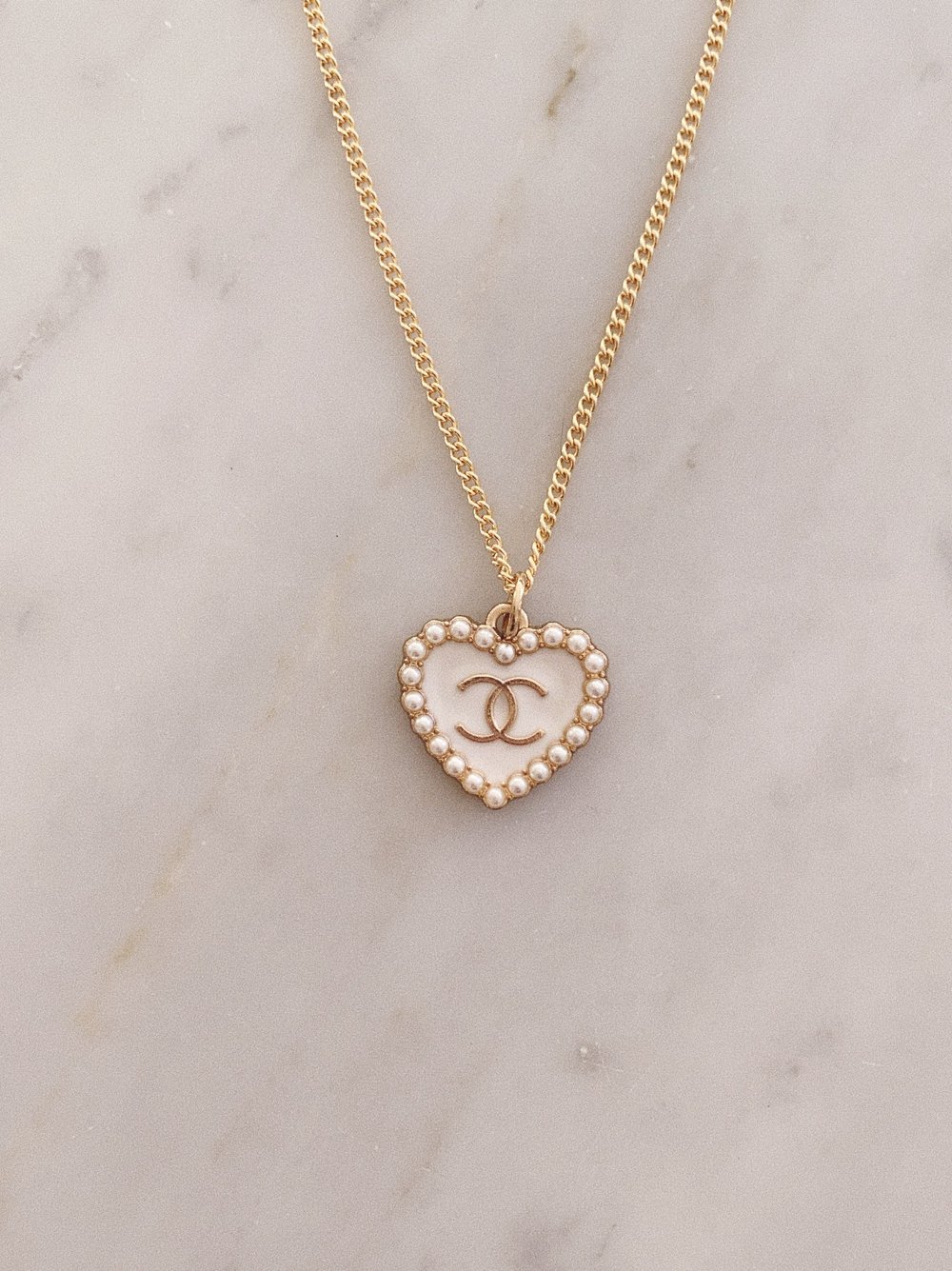 Gold Necklace with White Heart Pendant —