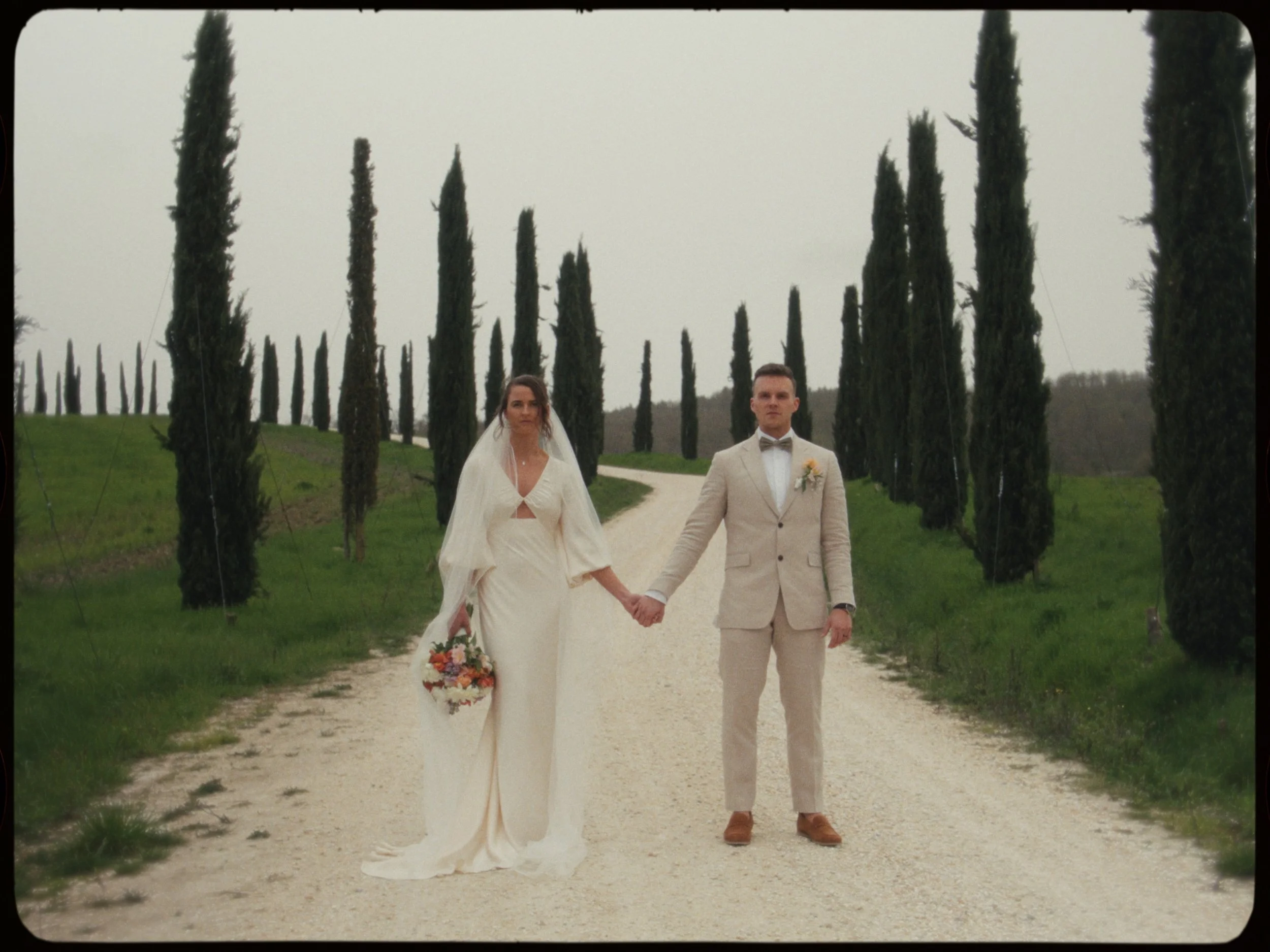 couple standing in the middle of road in italy for an elopement videography shoot