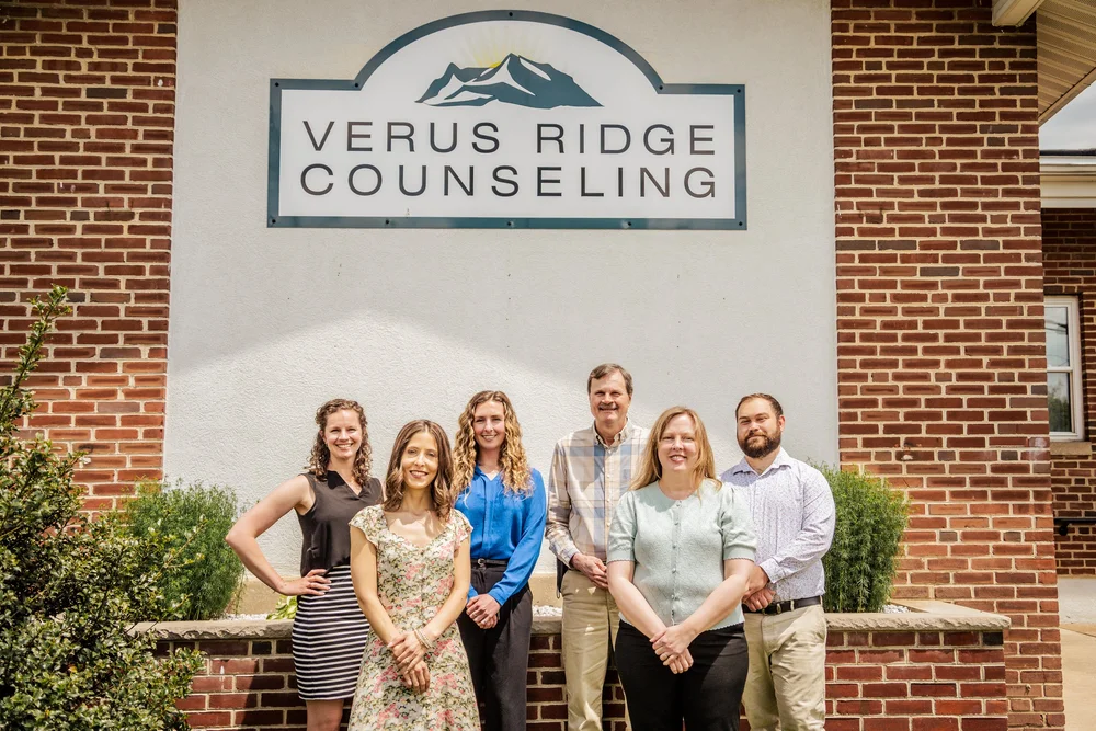 The Verus Ridge Counseling team outside the office beside the practice sign