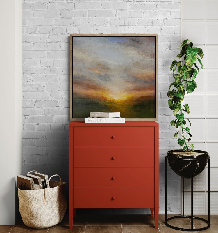 Molten Sunset Abstract sunset painting on canvas sitting on a red cabinet