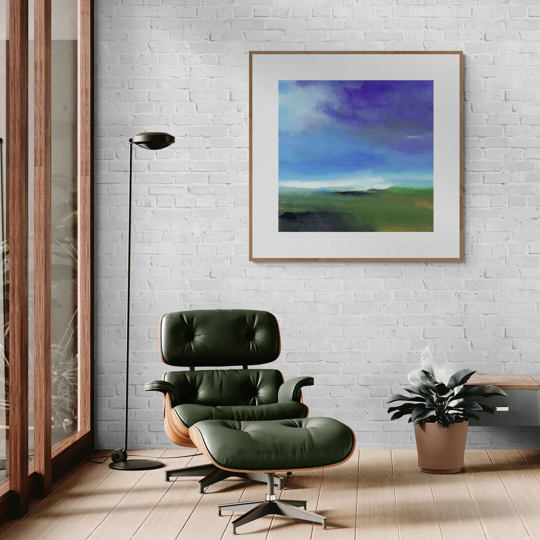 Abstract seascape painting framed hanging on wall styled in modern room above armchair and floor lamp