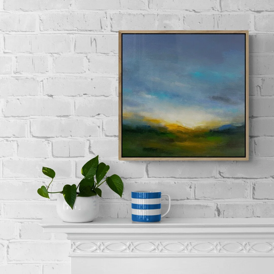 Stretched canvas painting hanging on white bricked wall above a mantelpiece with mug and plant
