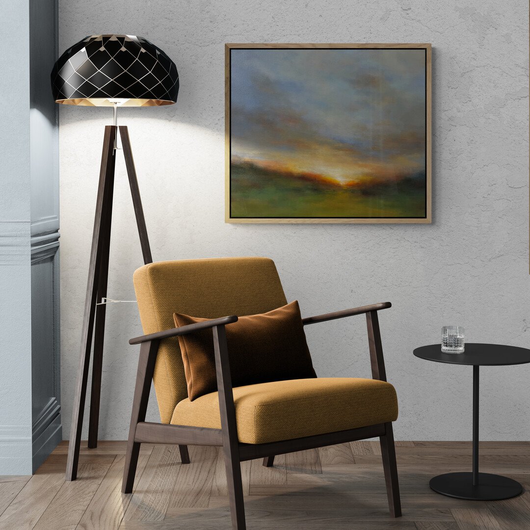 Sunset Impressionist painting hanging on wall above an armchair and floor lamp