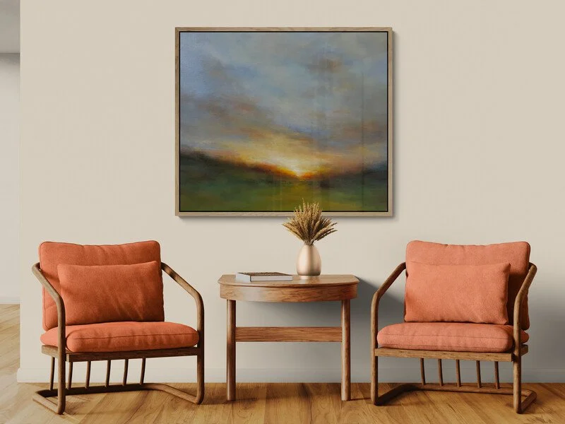 Silent Dawn impressionist sunrise painting hanging on a wall above two chairs and a coffee table