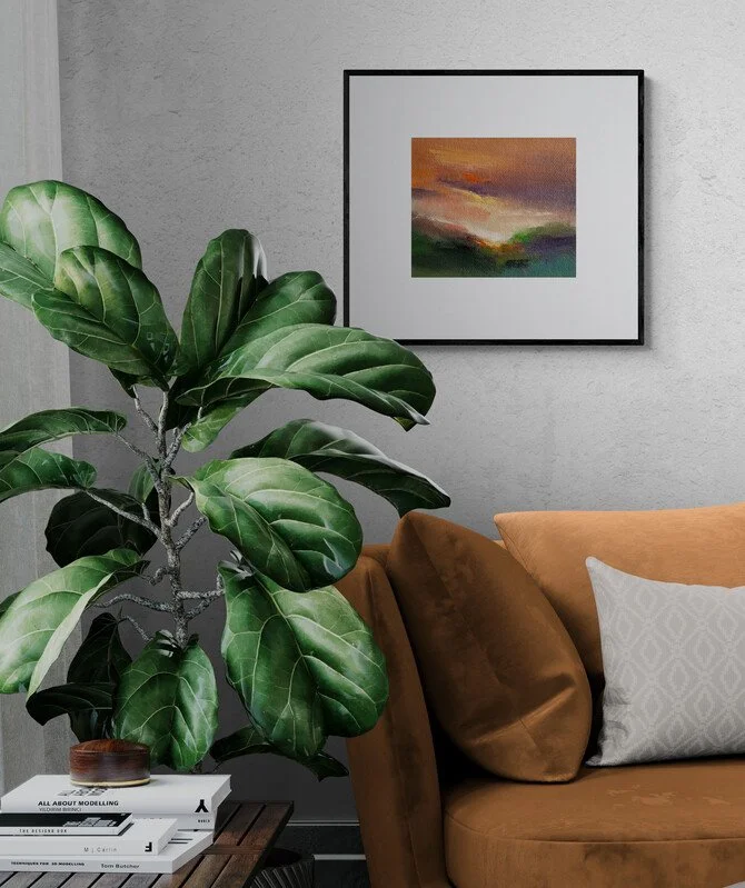 Small abstract sunset painting framed hanging on living room wall above sofa and plant