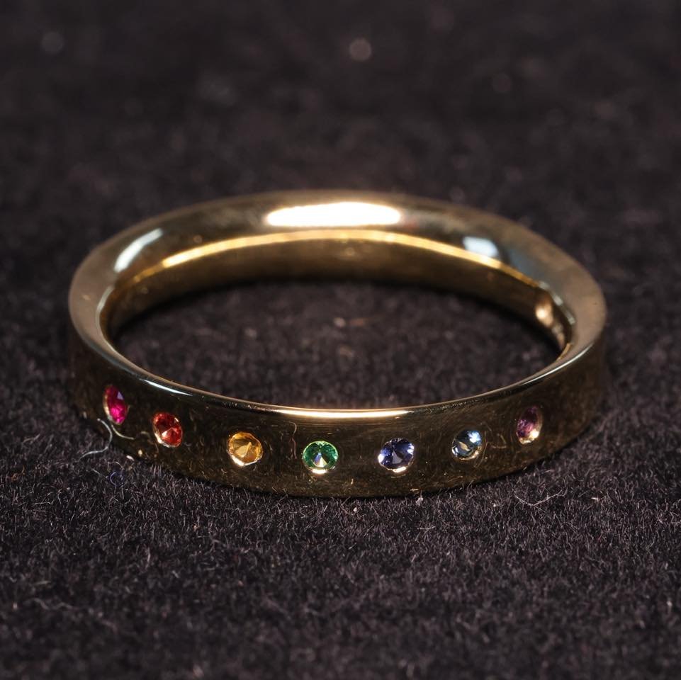 This beauty of an 18ct yellow gold ring is set with a Ruby, Orange Sapphire, Golden Yellow Citrine, Emerald, Sri Lankan Sapphire, London Blue Topaz, and a Dark Amethyst - perfectly displaying the colours of the rainbow that God hung in the sky to rem