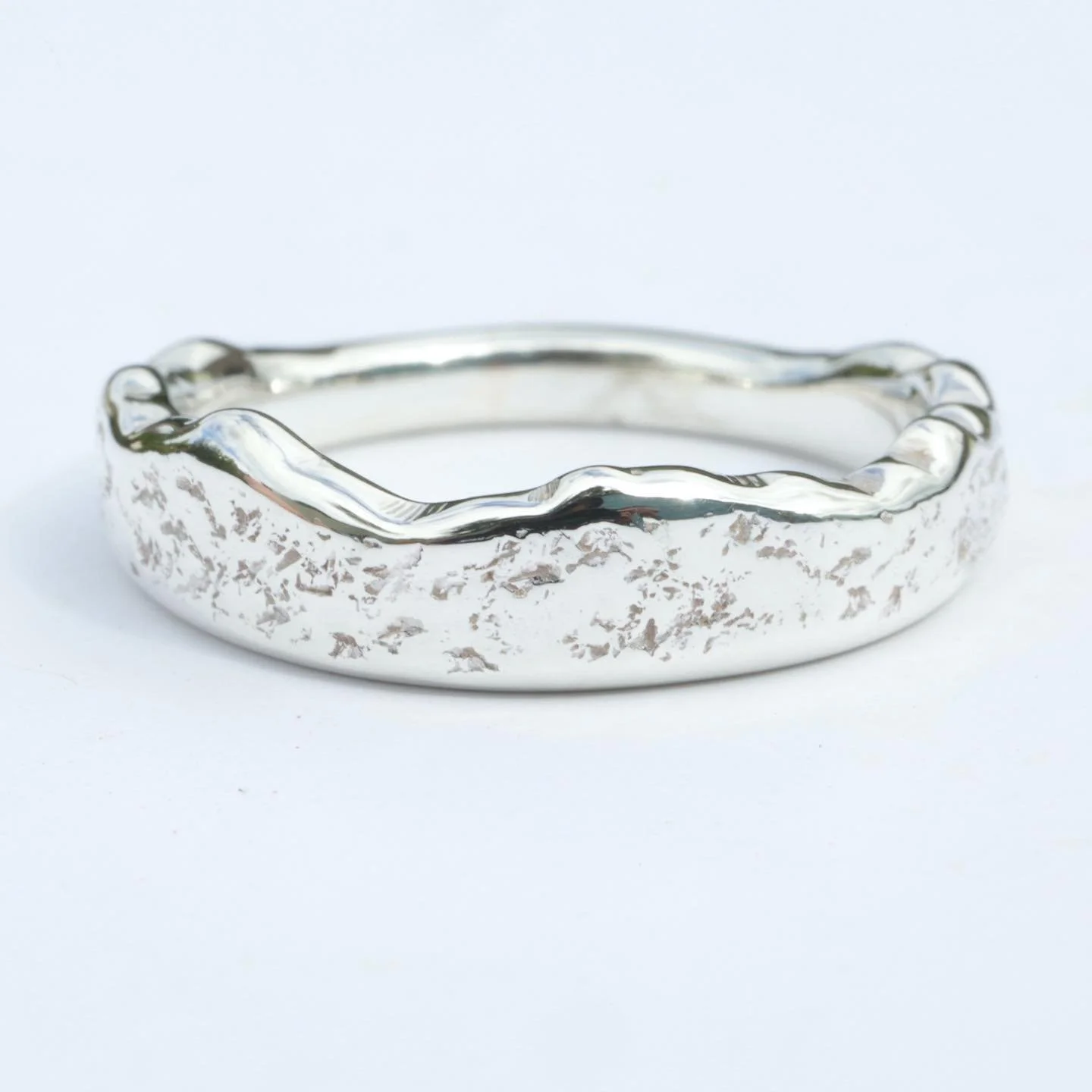 Part of the Mourne collection, this ring is shaped to show the exact outline of the Mourne Mountains in County Down, showcasing the entire silhouette from where the mountains sweep up from the sea. The metal has been textured with Mourne granite, lin