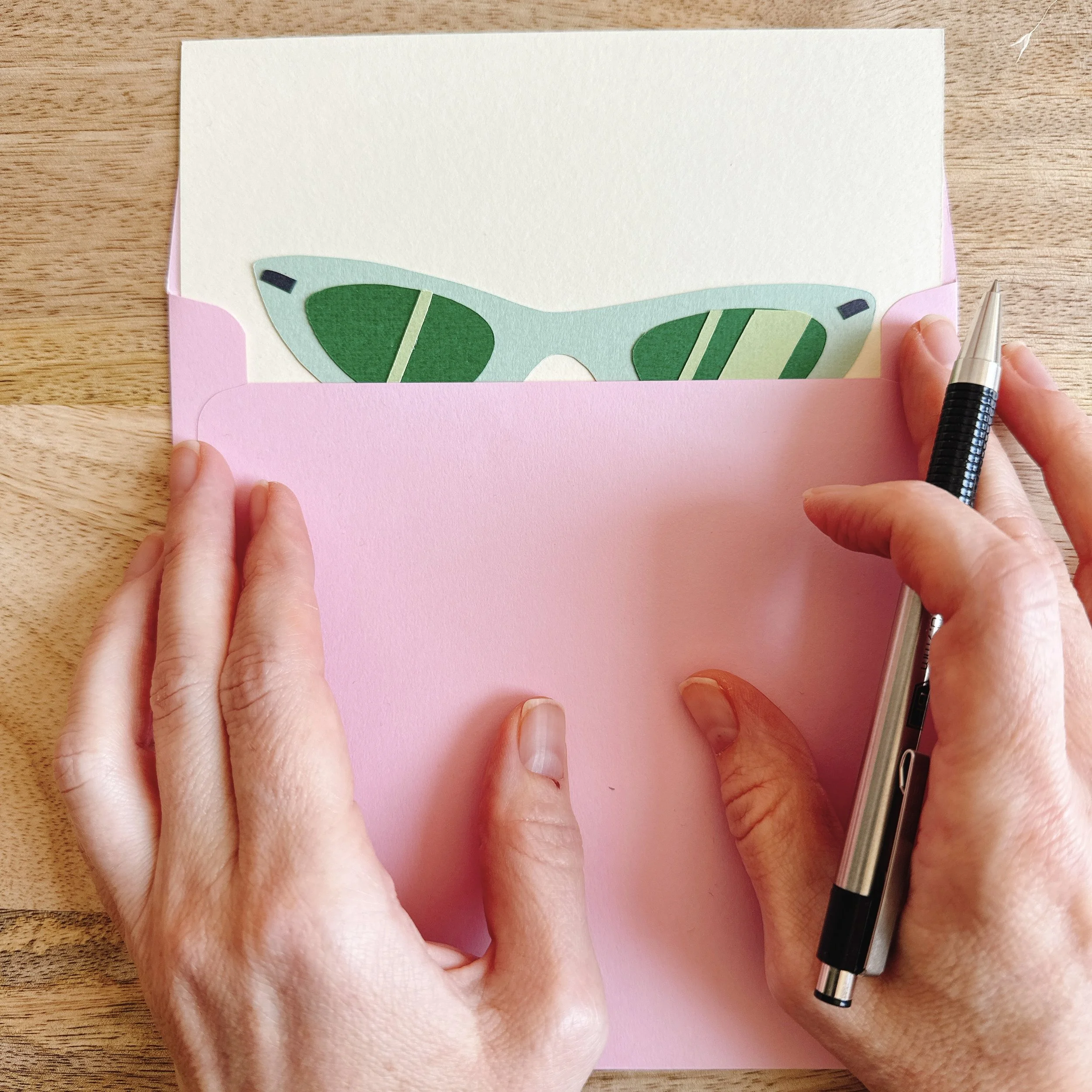 Papercut collage Cat Eyes — 6x6 inch artwork of green cat-eye sunglasses, symbolizing style and attitude.