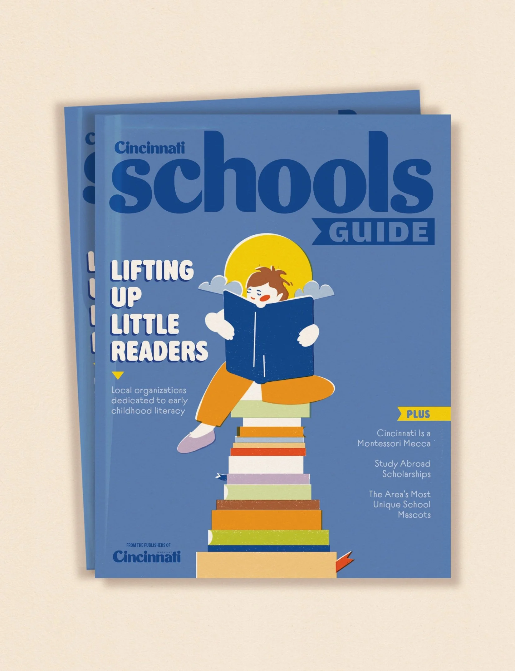 Cincinnati Schools Guide 2026 magazine cover illustration by Veronika Timokhina, child reading on stack of colorful books against blue sky, published by Cincinnati Magazine