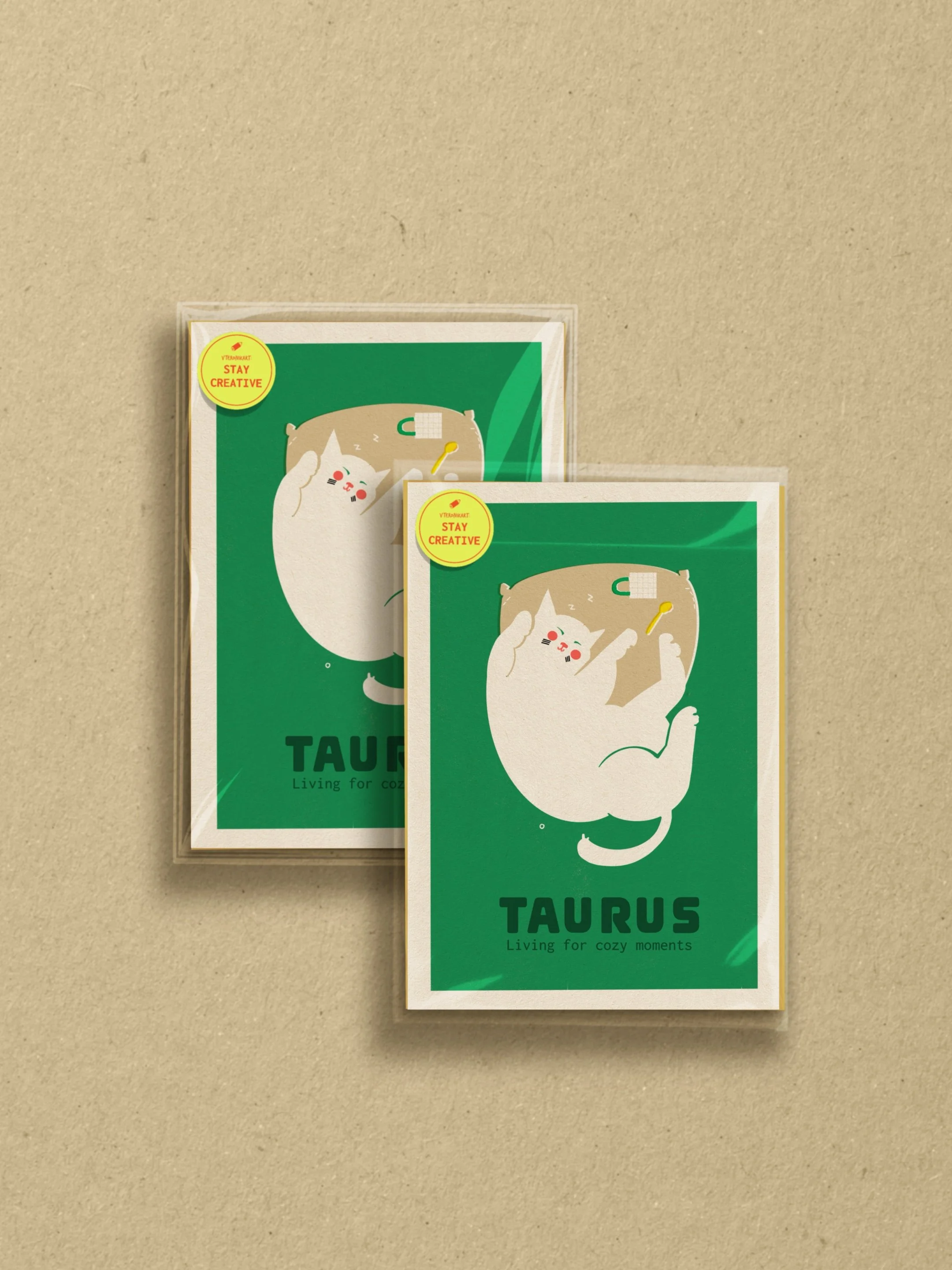Taurus zodiac art print: white cat lounging with a pillow on green background. Text: "Taurus Living for cozy moments." By Vteronikart