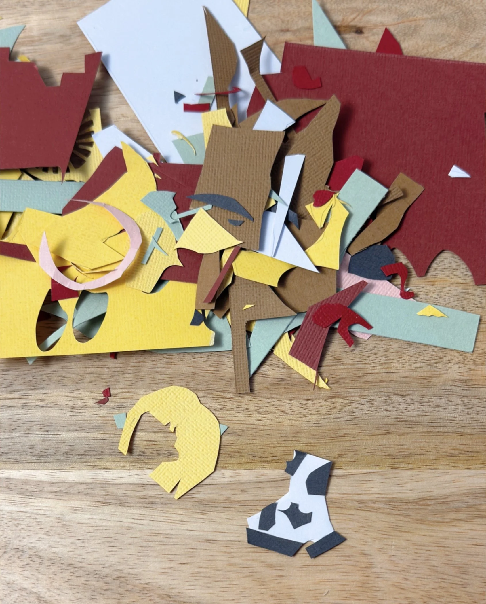 Paper scraps from the process of creating a Capricorn hand-cut collage
