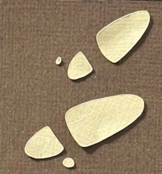 Hand-cut paper collage artwork by contemporary paper artist, featuring minimalist compositions made from layered colored paper