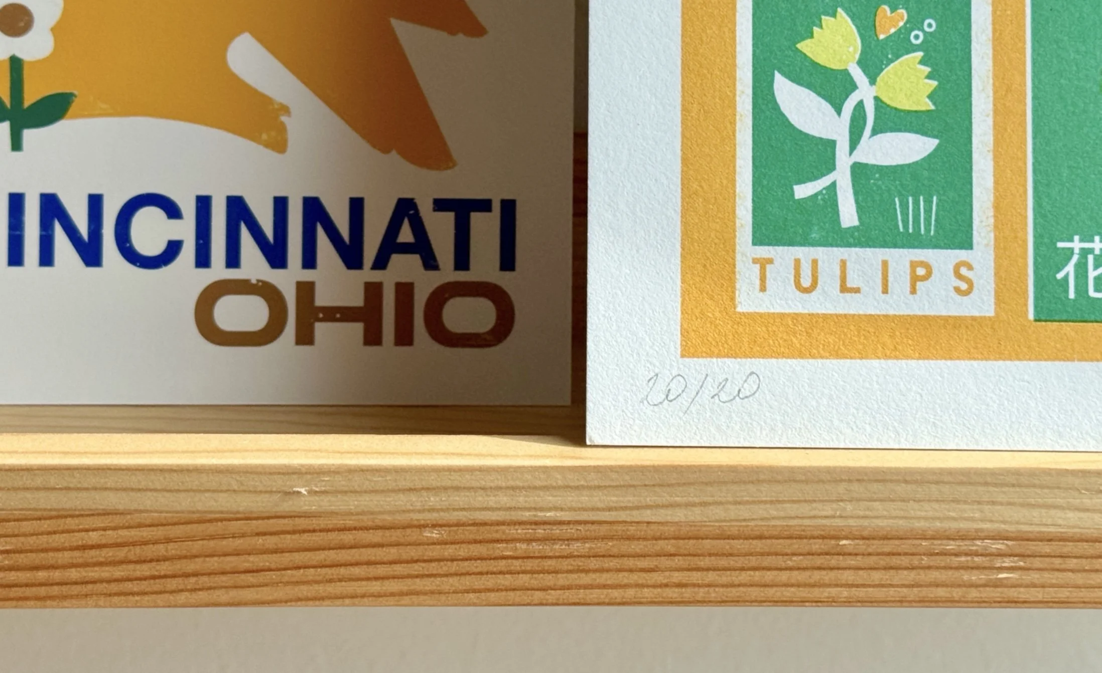Close-up of a giclée art print on textured paper, hand-signed and numbered 20/20 in pencil, showing fine print detail.