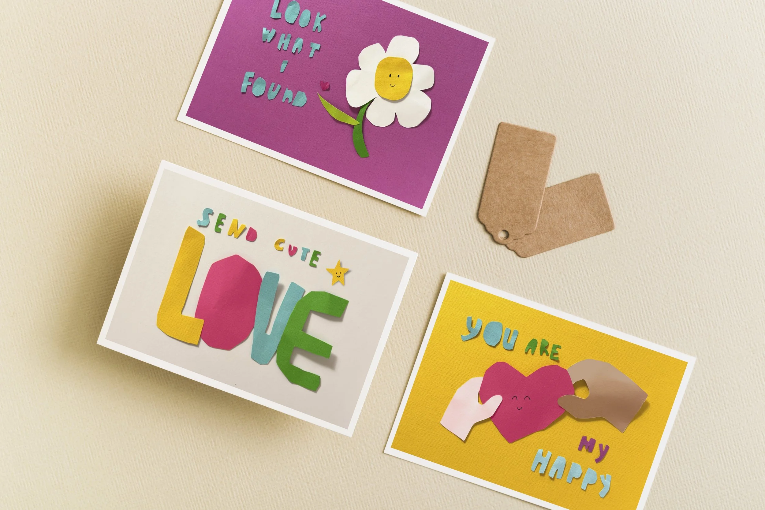 Three hand-cut paper Valentine’s Day cards arranged together, featuring playful shapes, bright colors, and tactile paper textures.