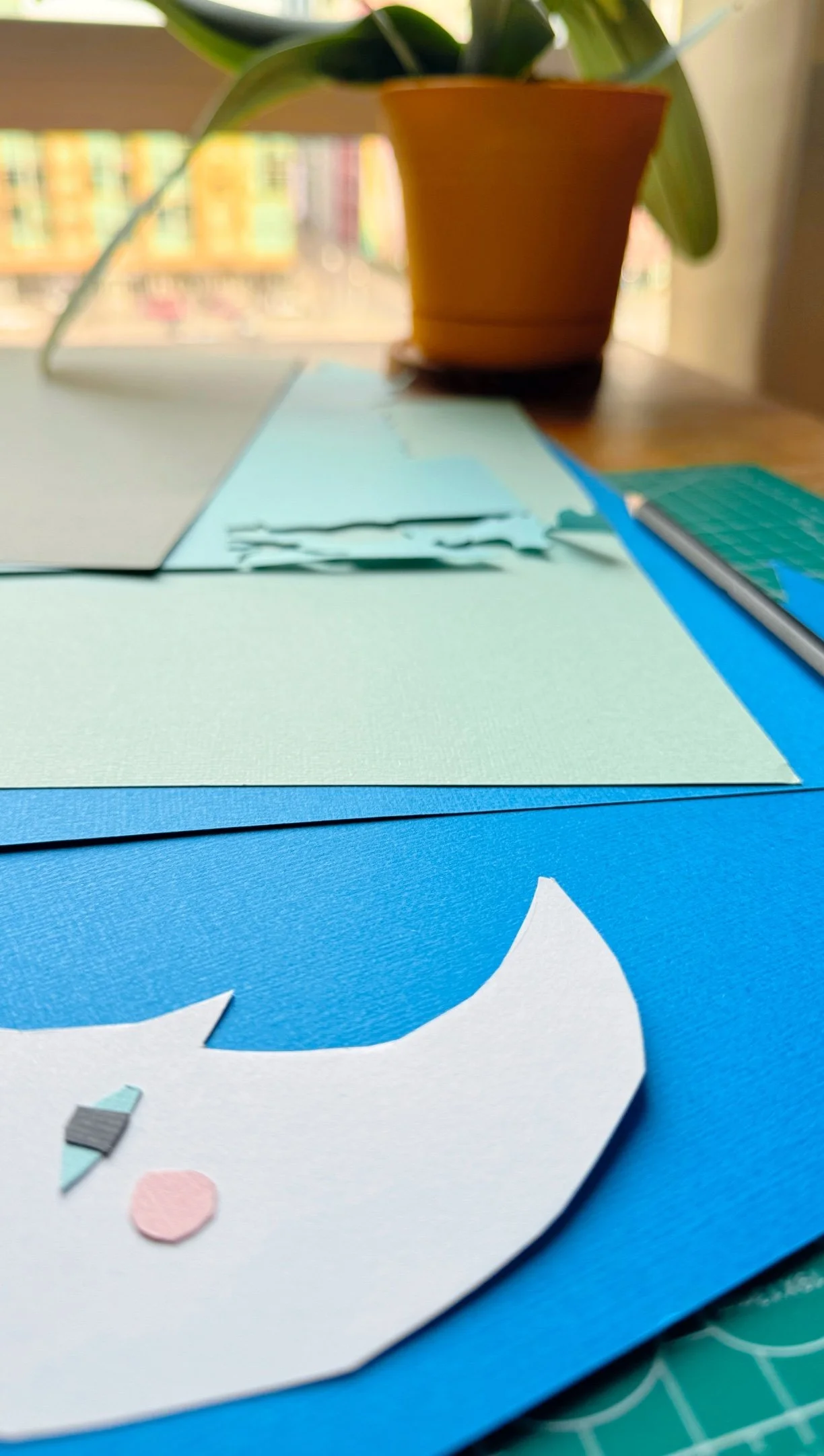 Close-up detail of hand-cut paper moon showing layered paper texture