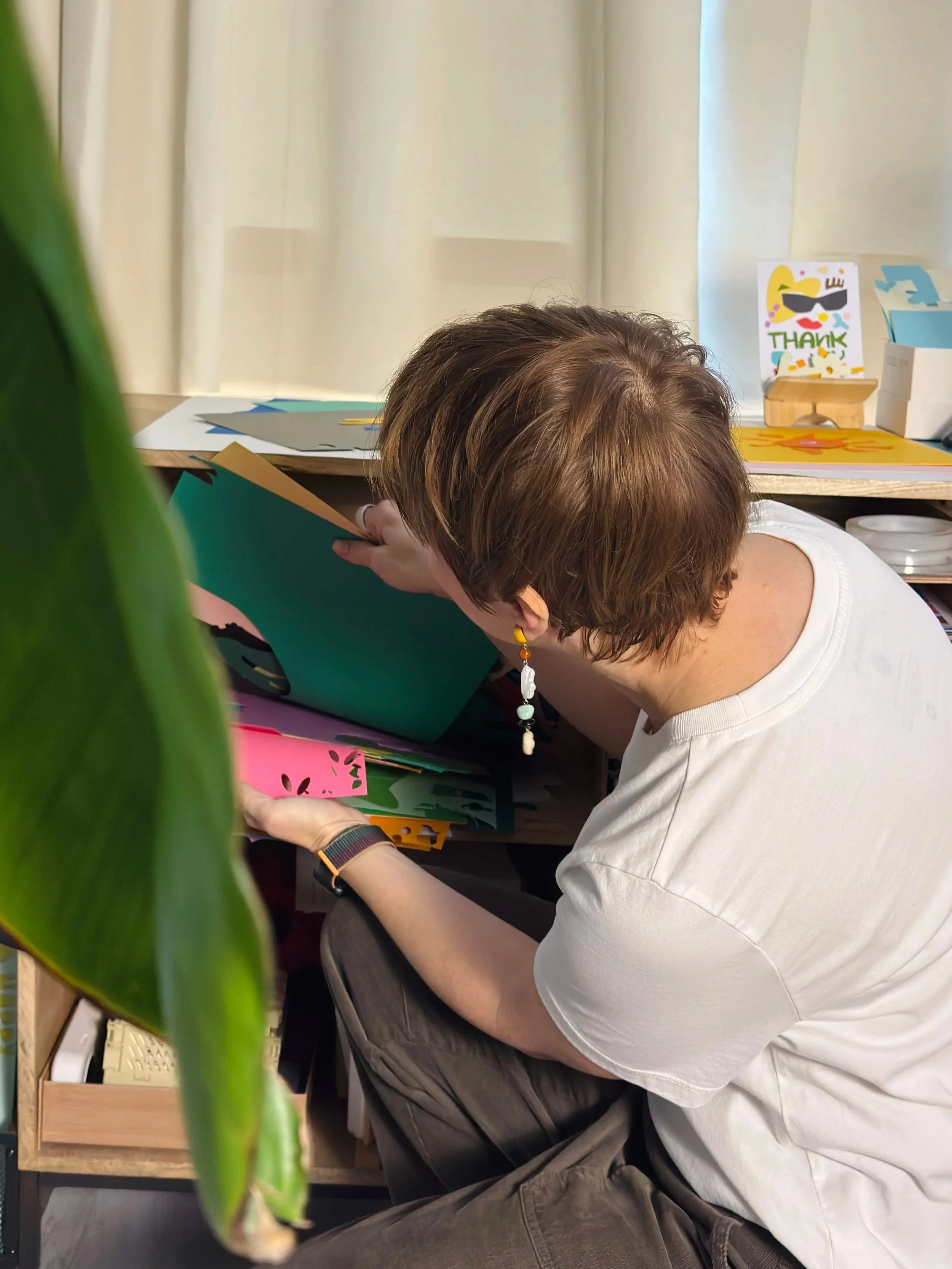 Hand-cut paper collage artwork by contemporary paper artist, featuring minimalist compositions made from layered colored paper