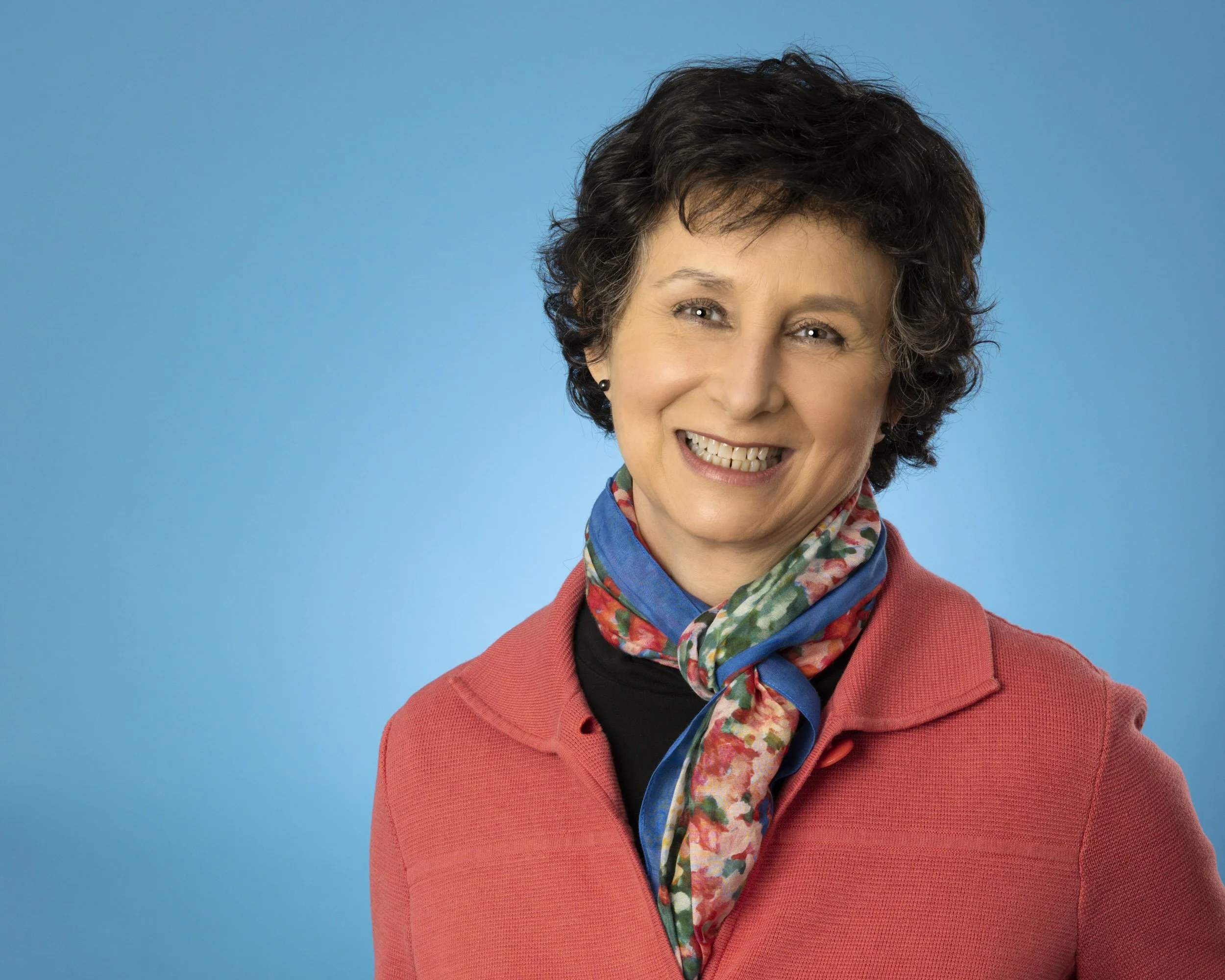 a fun blue backdrop for a corporate brand headshot