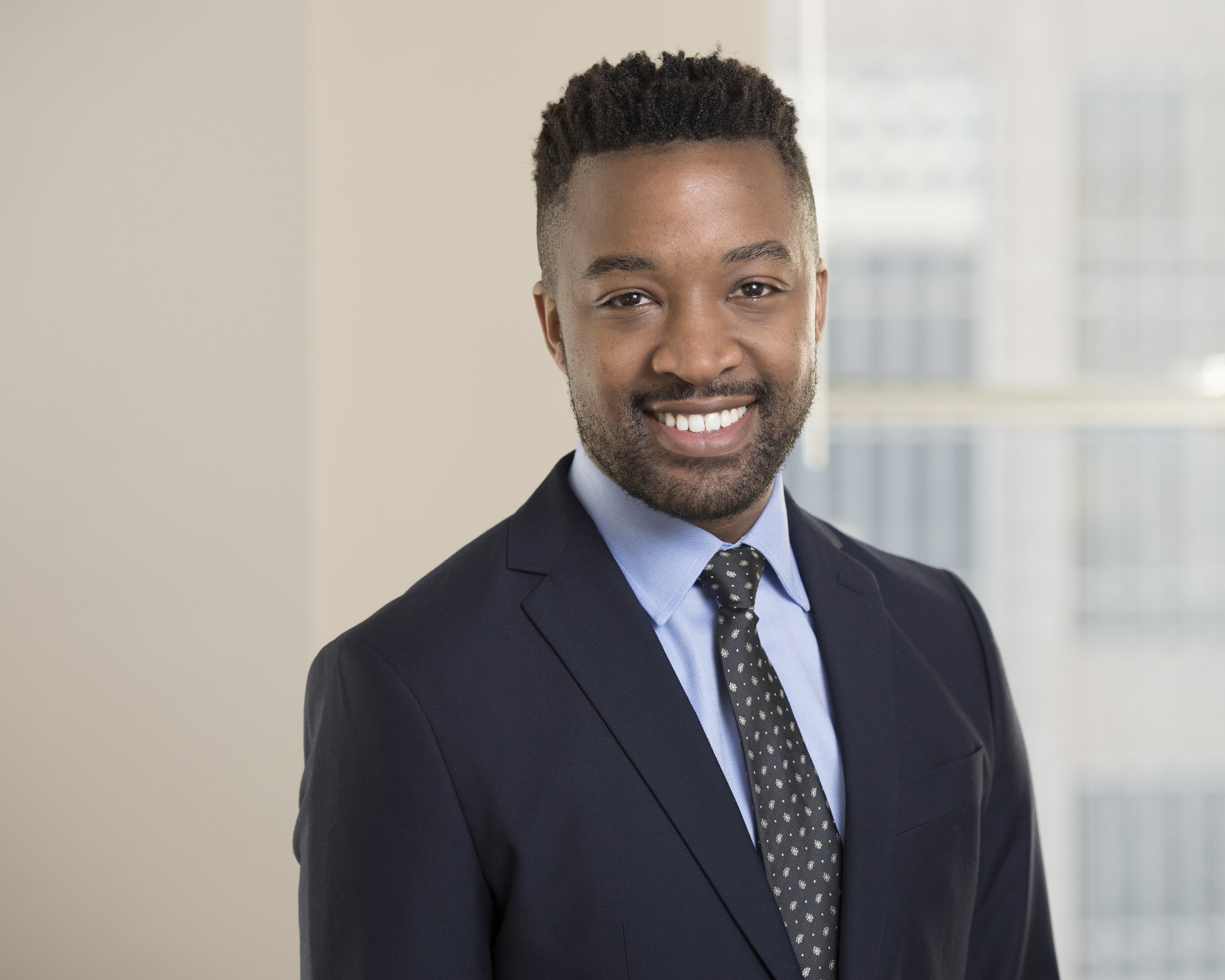 an engineering consultant headshot with a bright background for an upscale brand
