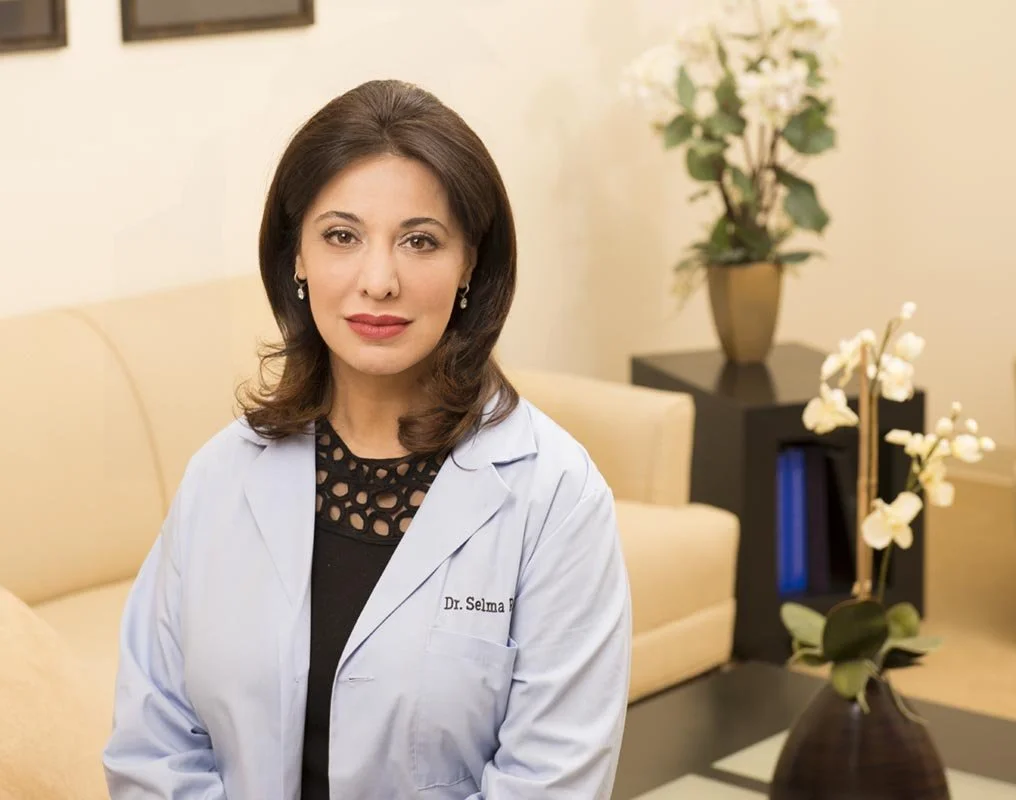 Chicago medical spa doctor's portrait taken in her office. This woman is a physician in a Lincoln Park wellness center. The waiting room had some couches and flowers which made for  beautiful health care photography.