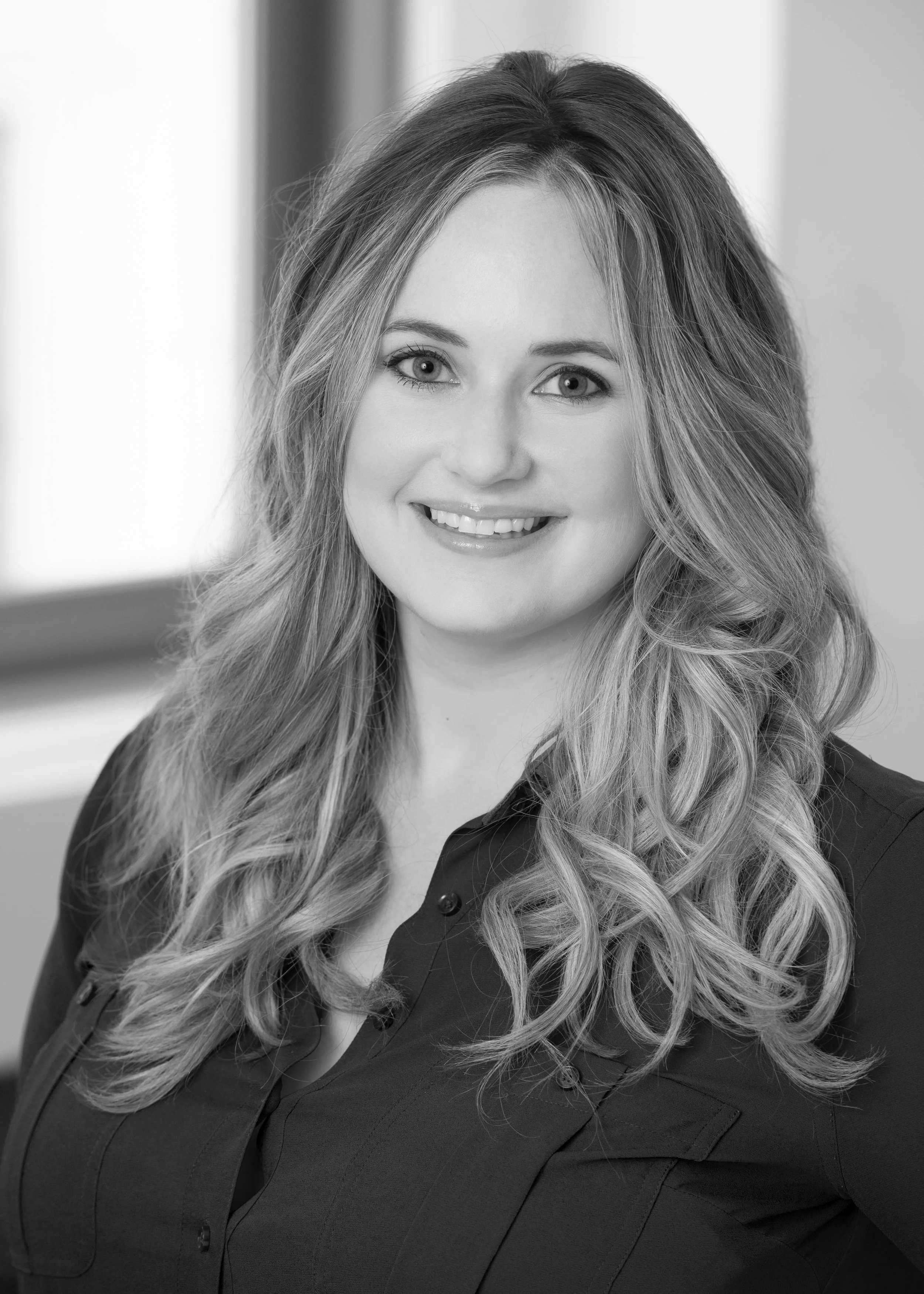 a public relations professional headshot in black and white