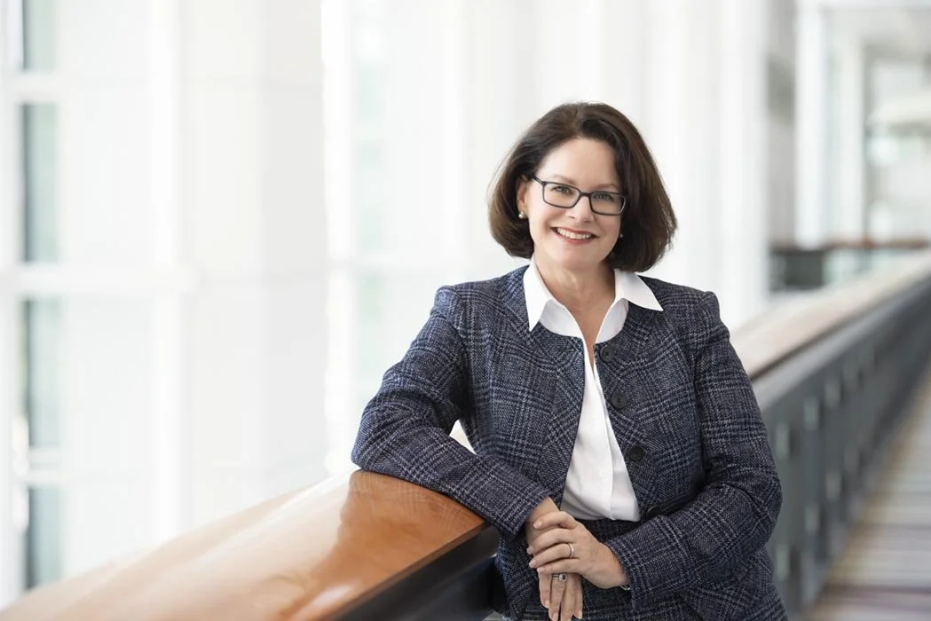 An upscale and modern business portrait in Chicago of a CEO. The very bright windows go off to camera right out of focus and give a luxury brand to the photo. A photographer in Chicago captured this photo at McCormick place using natural light.