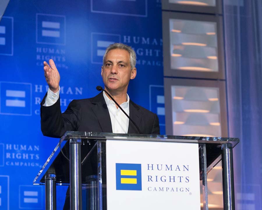 A man speaking at a podium during a Human Rights Campaign event, with the organization's logo displayed behind him.