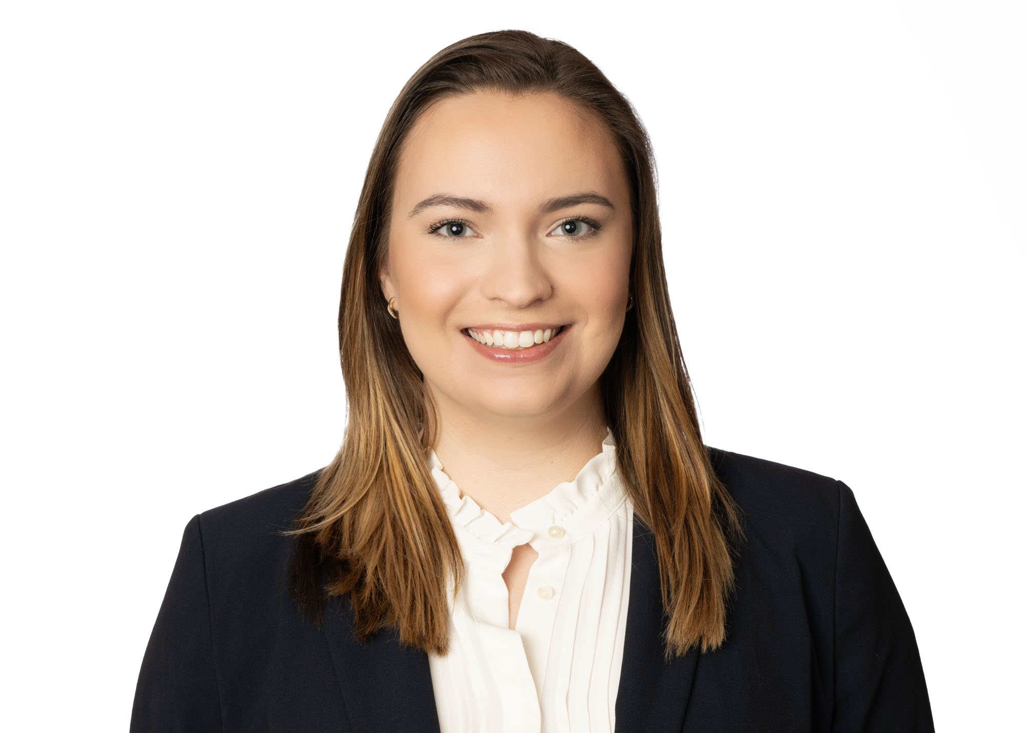 Chicago headshot photographer captures a patent attorney on a flat white background. The woman is facing forward for an upscale look. She is wearing a nice suit and blouse for a corporate brand.