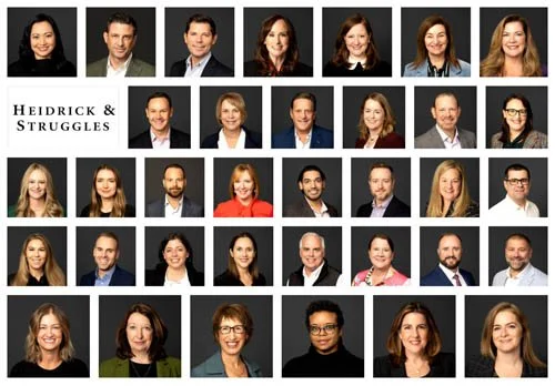 Group photo of multiple professional headshots arranged in rows, with a logo reading 'Heidrick & Struggles' in the upper left corner.