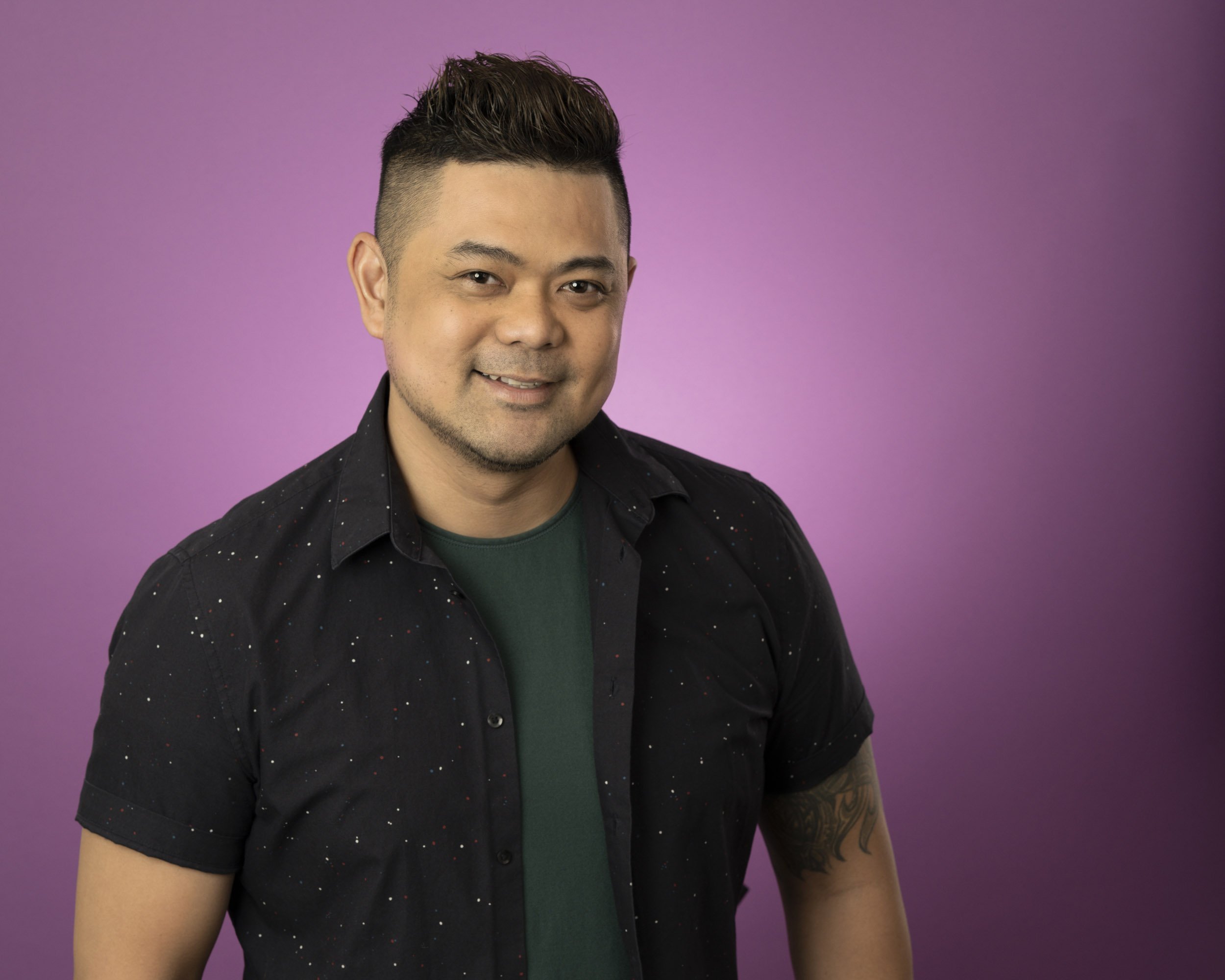 headshot with a purple backdrop