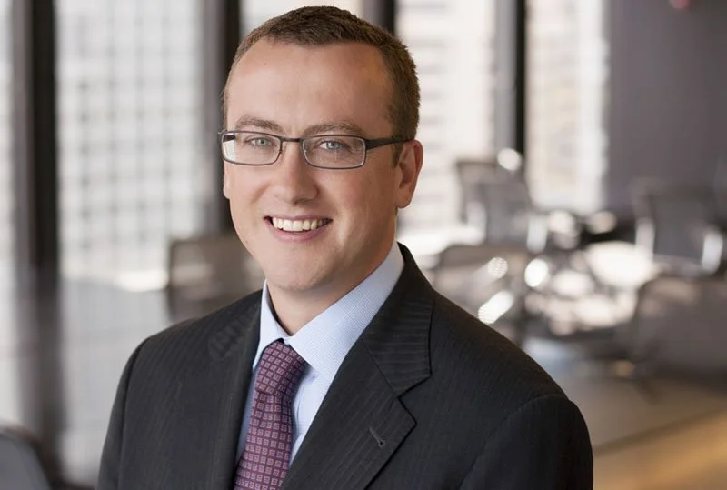 Headshot of an engineering consultant with the office in the background