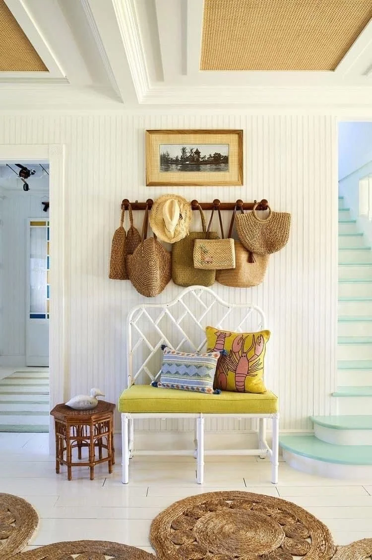 A hat rack with sun hats and straw bags as wall decor, via Pinterest