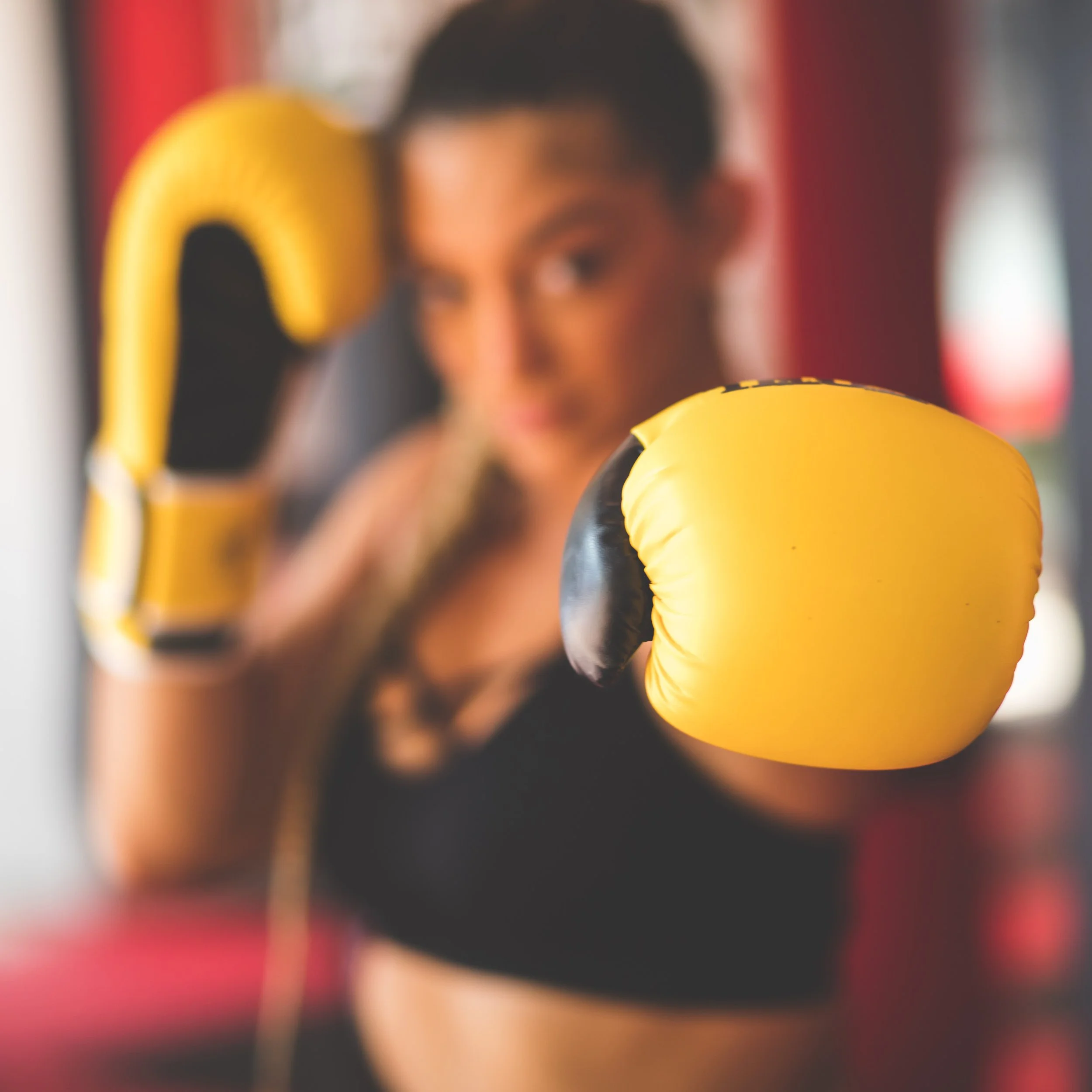 Female boxer with yellow gloves