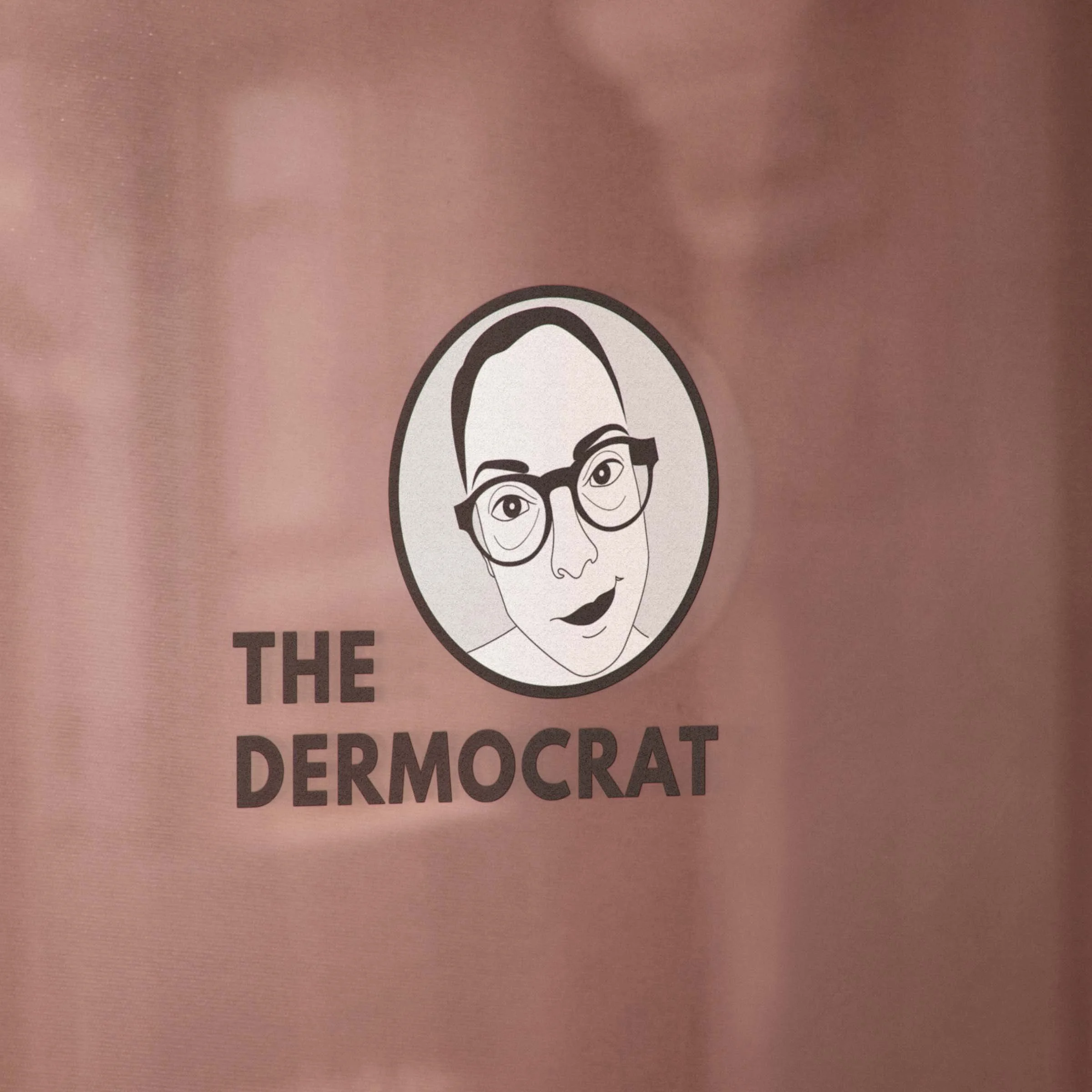 Caricature logo of The Dermocrat in window signage