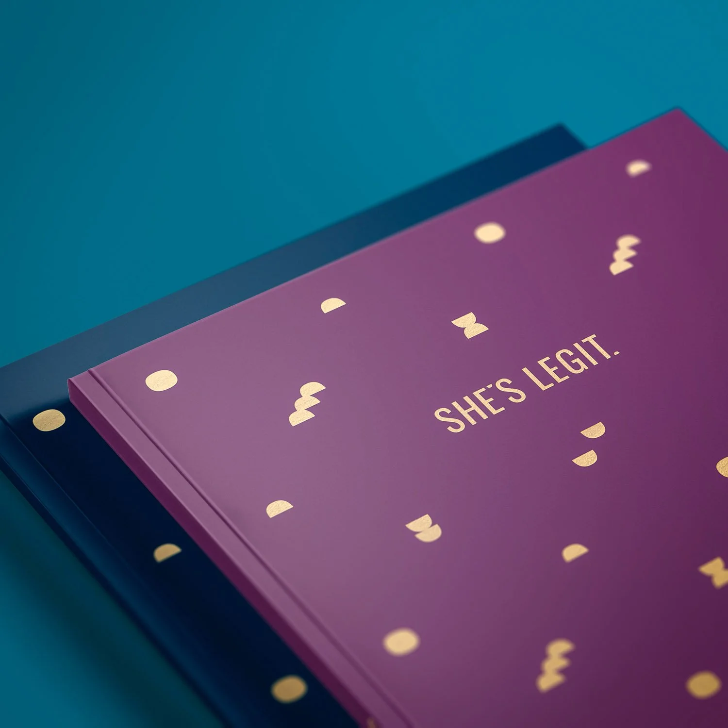 she's legit logo design on purple notebook