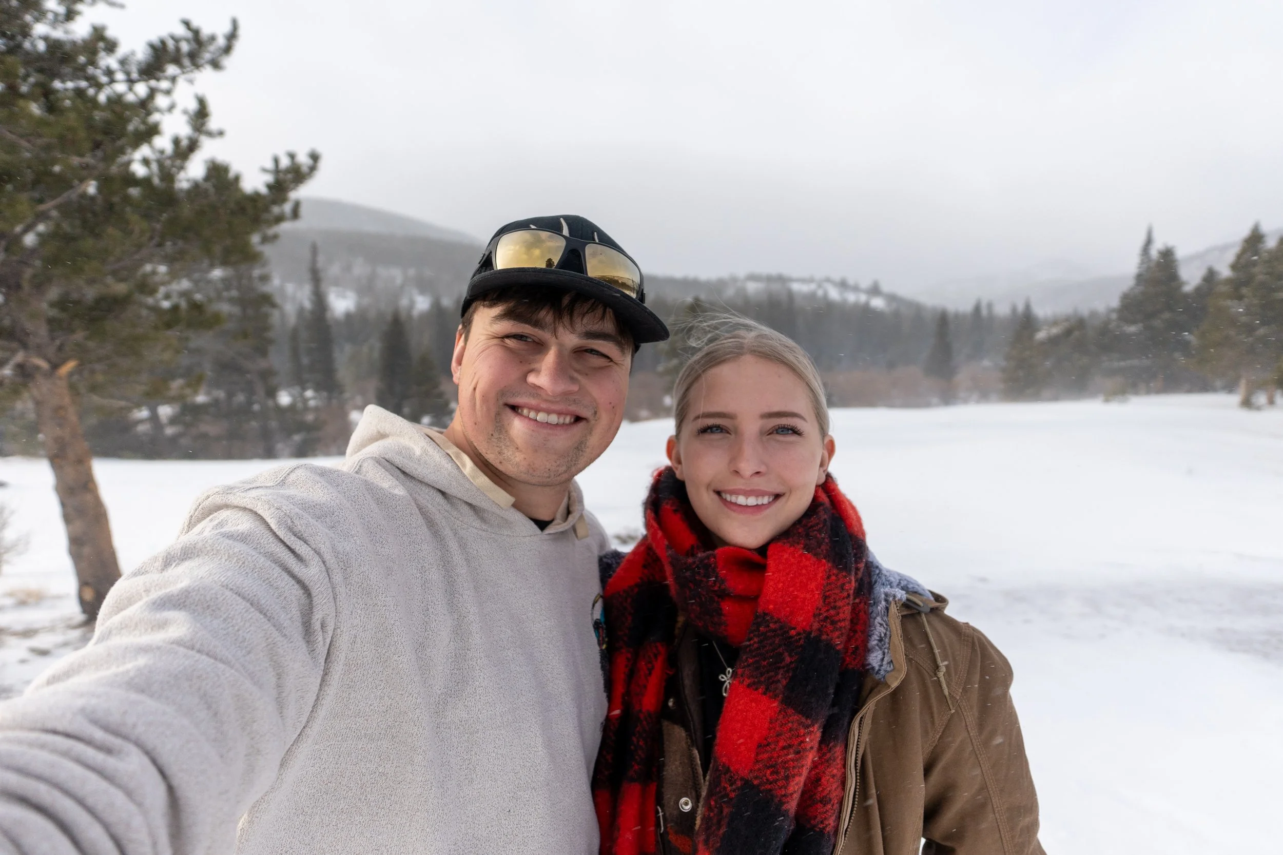 A photo of RJ and Aubrey Cianciarulo standing in front of a Rock wall together. RJ is wearing a Bass Pro Shops Green T-Shirt and Aubrey is wearing a Browing Black T-Shirt