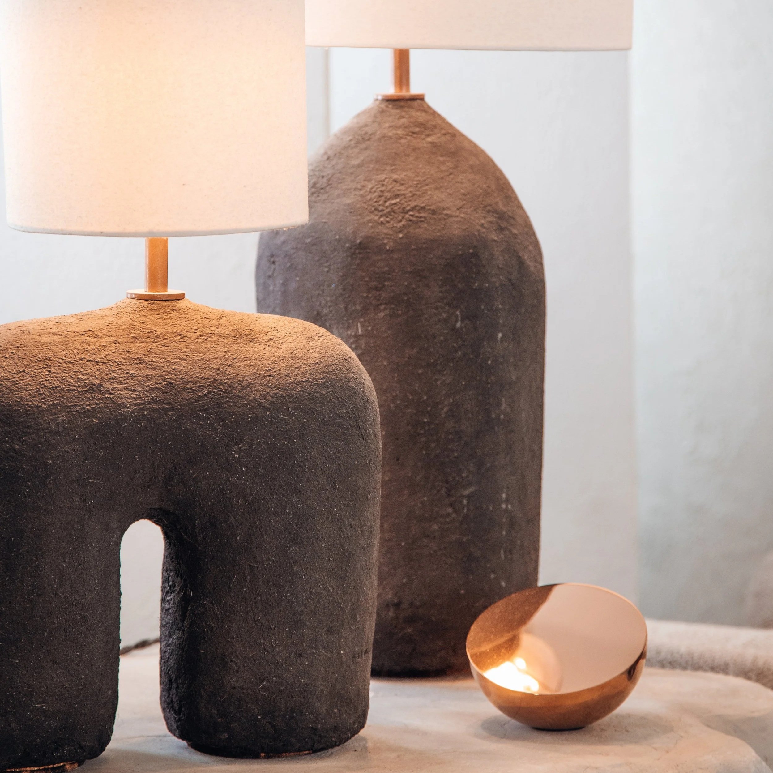 Organic hand-shaped lighting objects with a rough surface texture, named Philokalia.