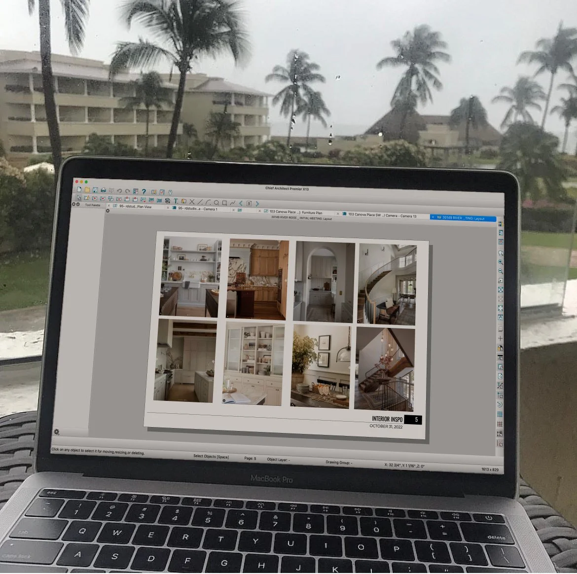 Remote work location showing a resort behind the laptop working document