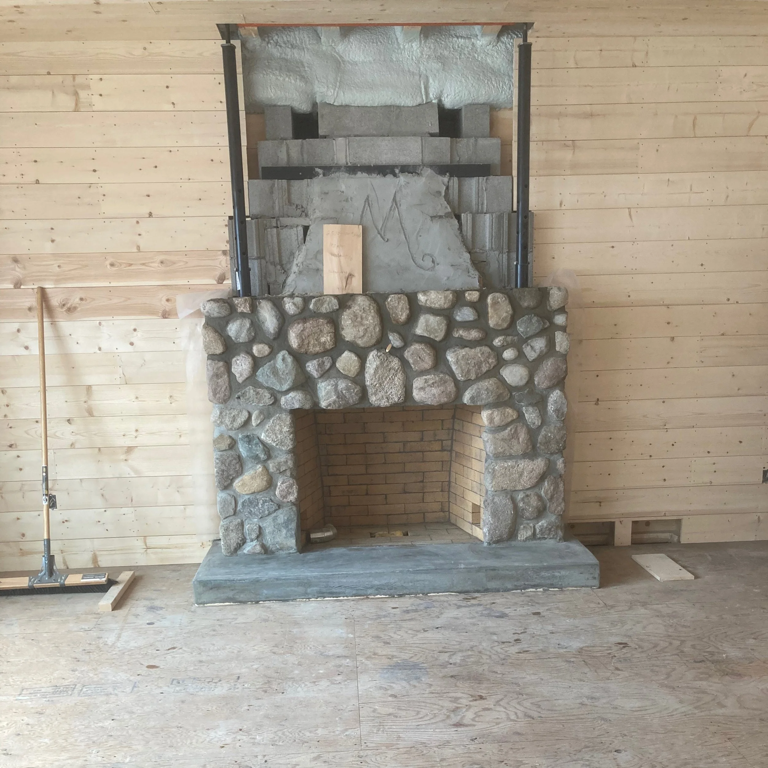 A newly built cottage featuring a repurposed masonry fireplace
