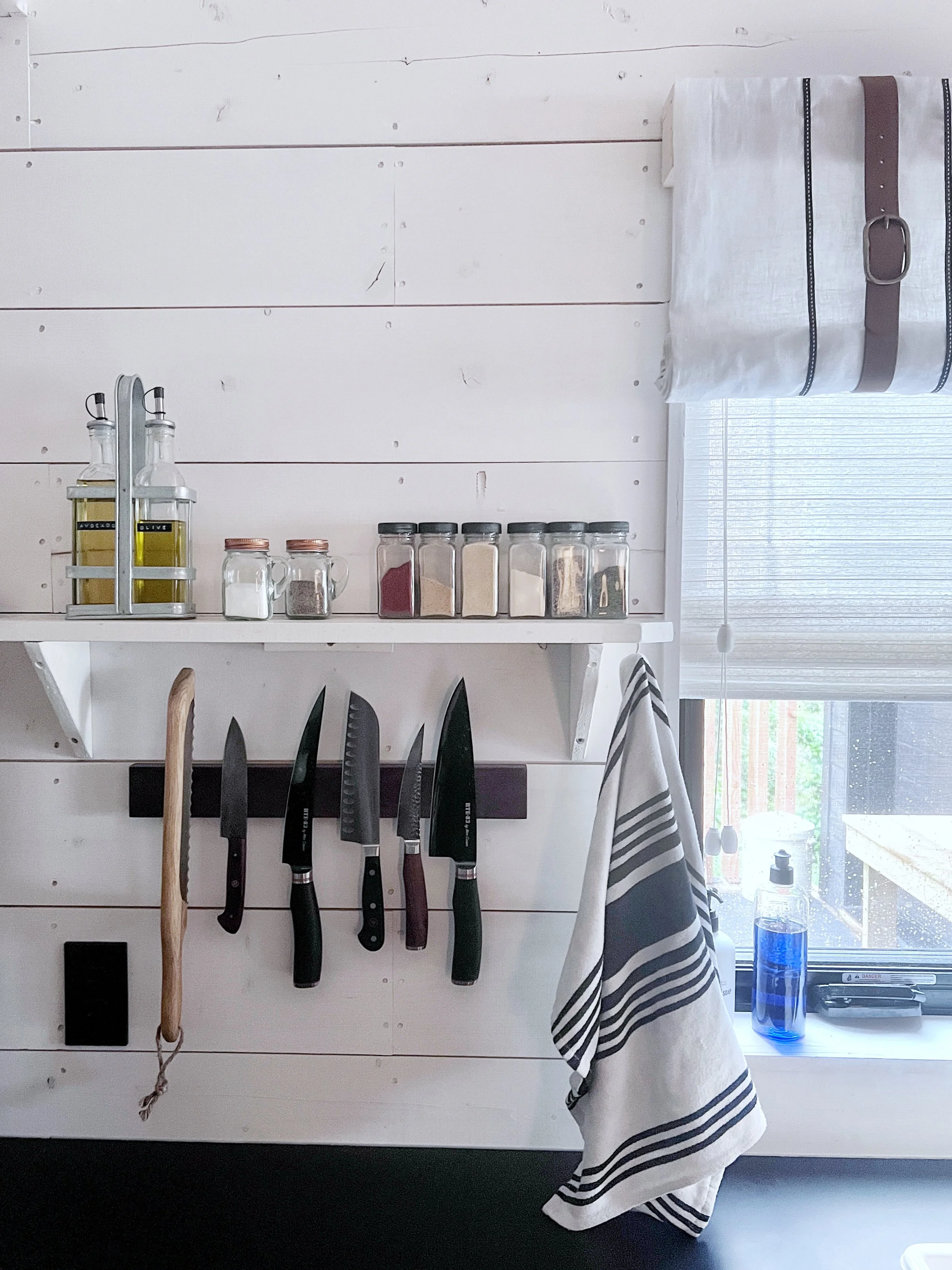 Kitchen details showcasing a spice shelf and a magnetic knife bar