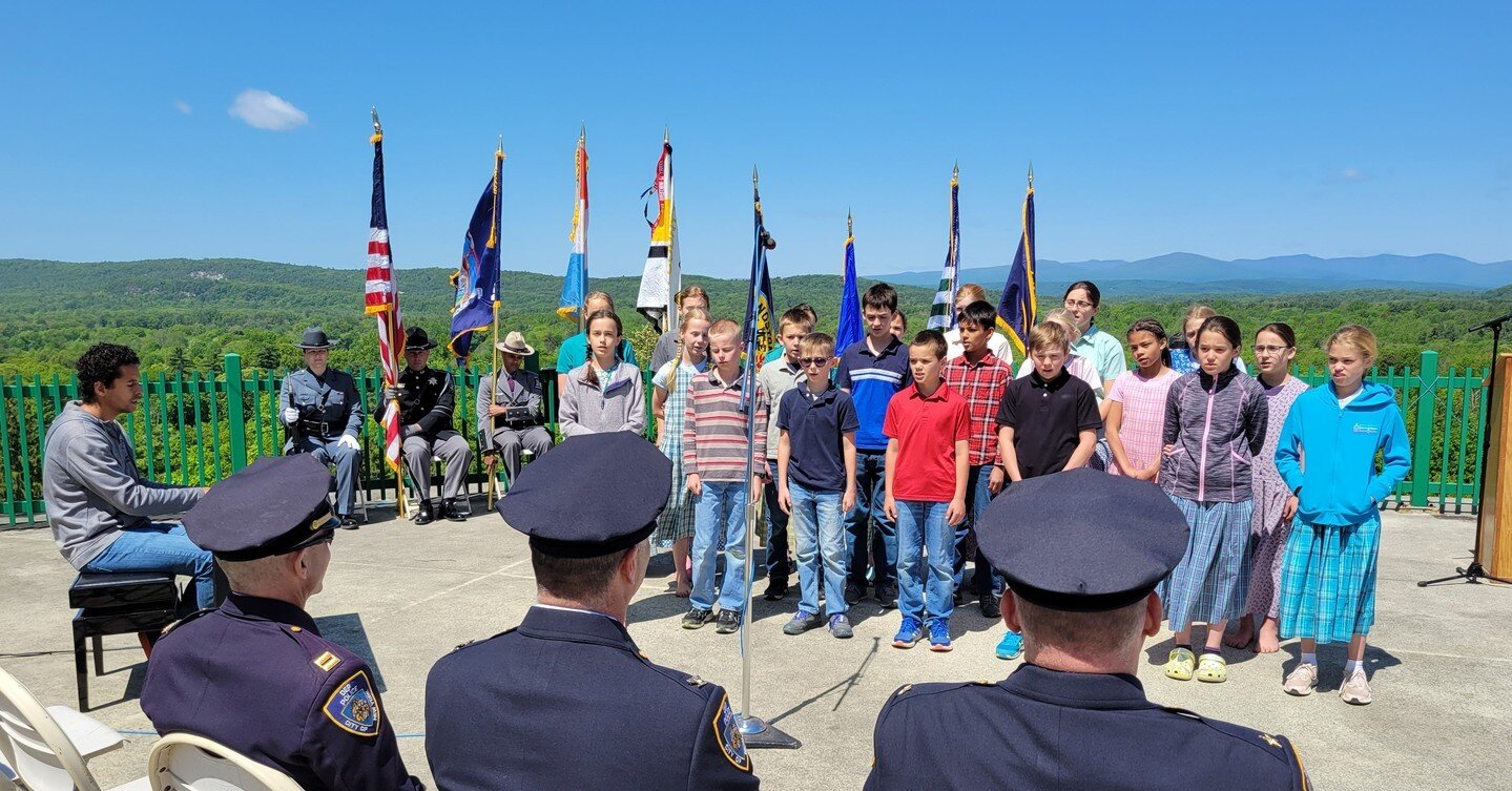 The Woodcrest community welcomed members of the Ulster County law enforcement community for their annual commemoration of the local, state, and federal police officers who have died in the line of duty. Students from the Woodcrest school sang at the 