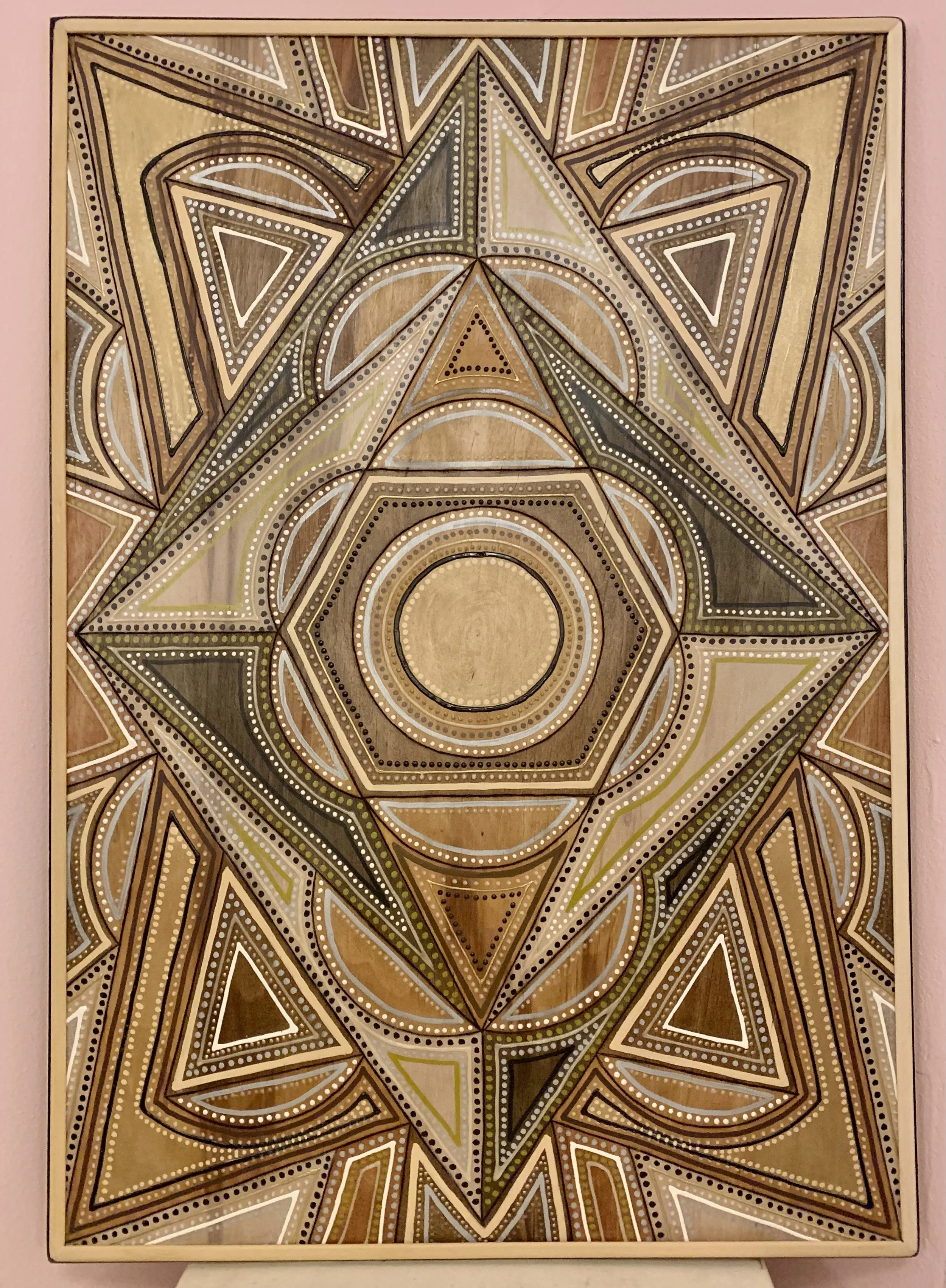 Geometric abstract art with layered triangles, circles, and lines in earth tones and white accents