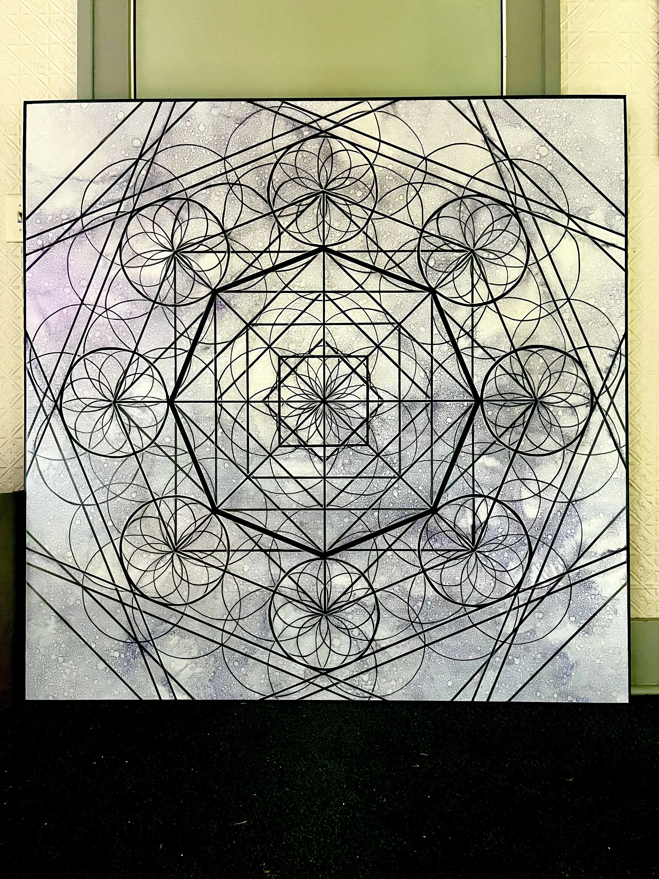 Geometric artwork featuring intricate black lines and circular patterns on a textured white background.