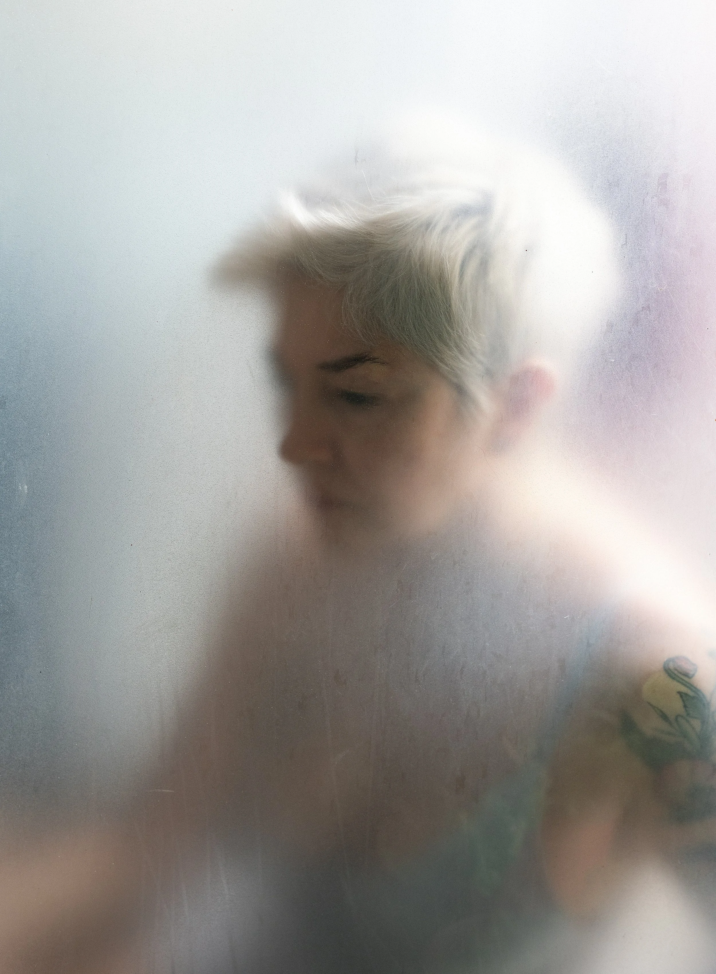 A person in the shower looks on