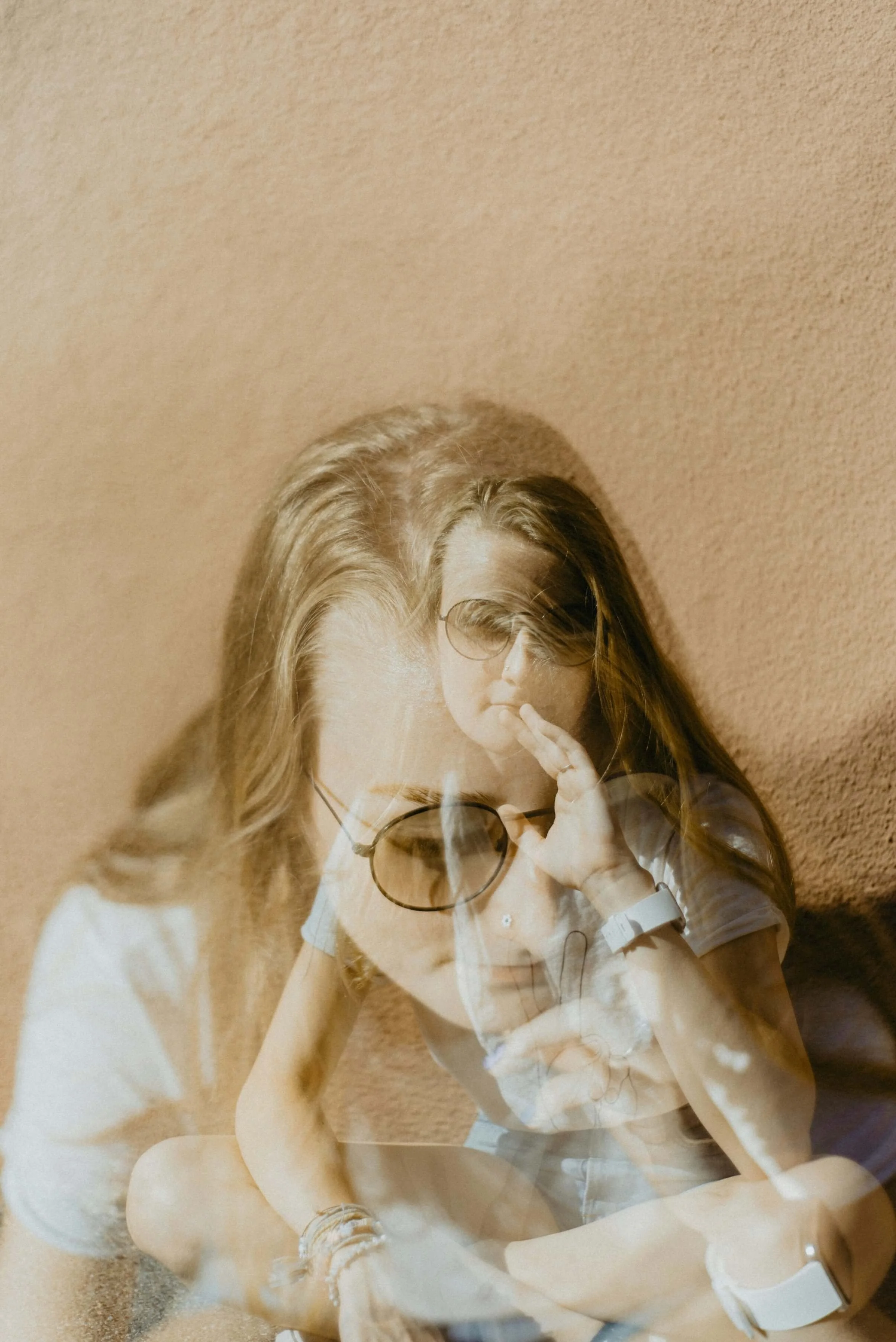 Double exposure photo of a white woman wearing sunglasses