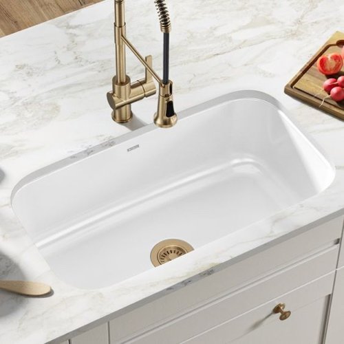 undermount white kitchen sink with brass hardware