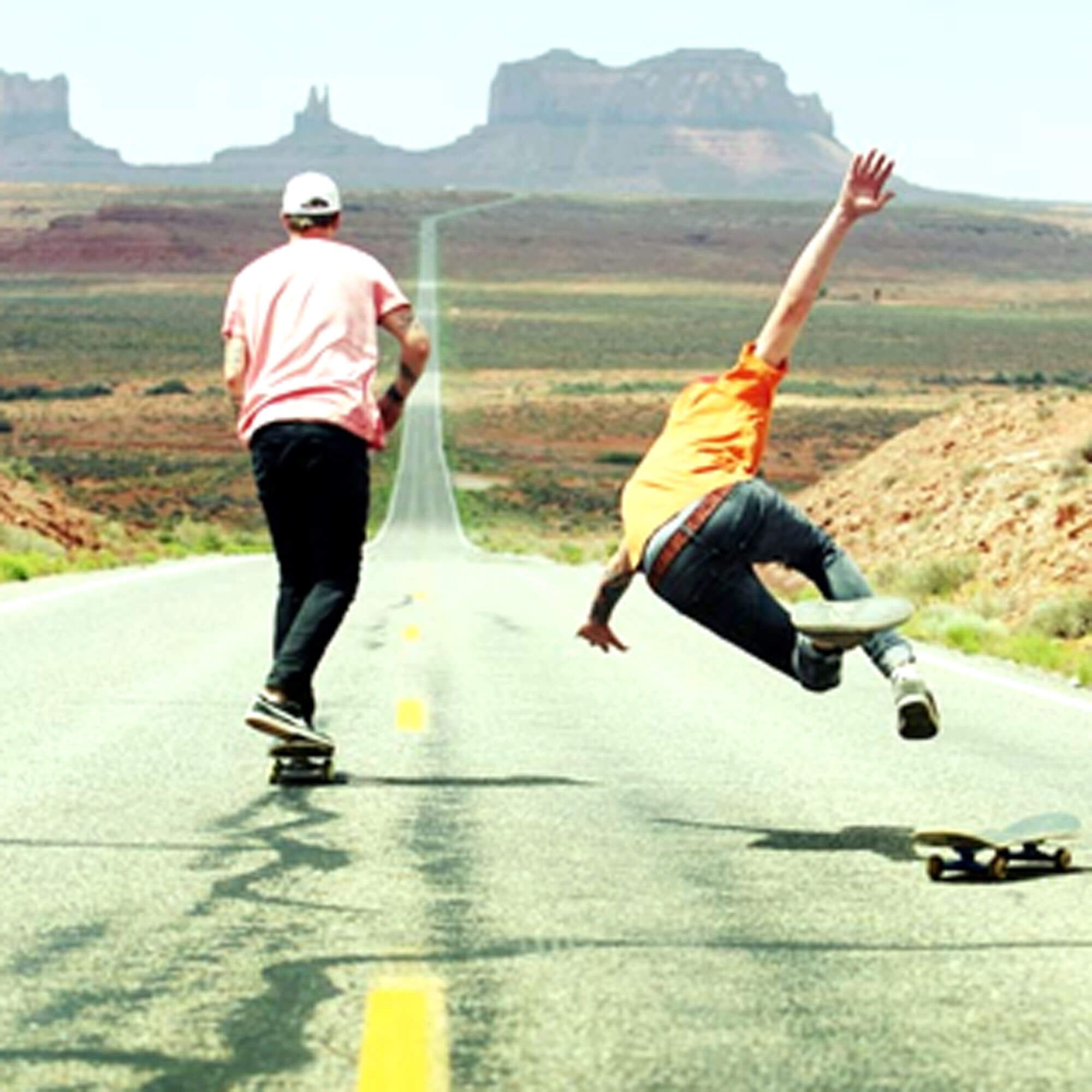 two-boys-skateboarding-downhill.jpg