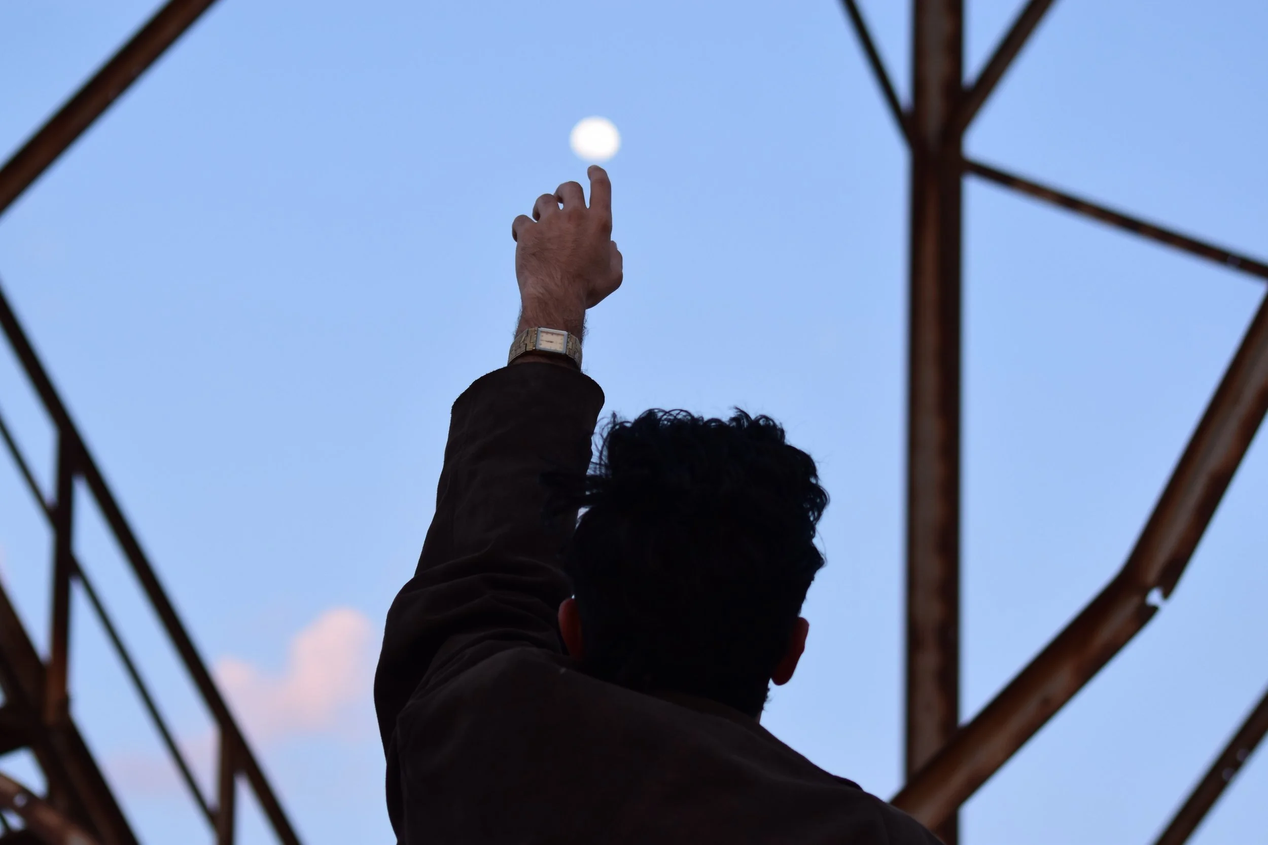 pexels-krar-hb-16479746 finger pointing to moon.jpg