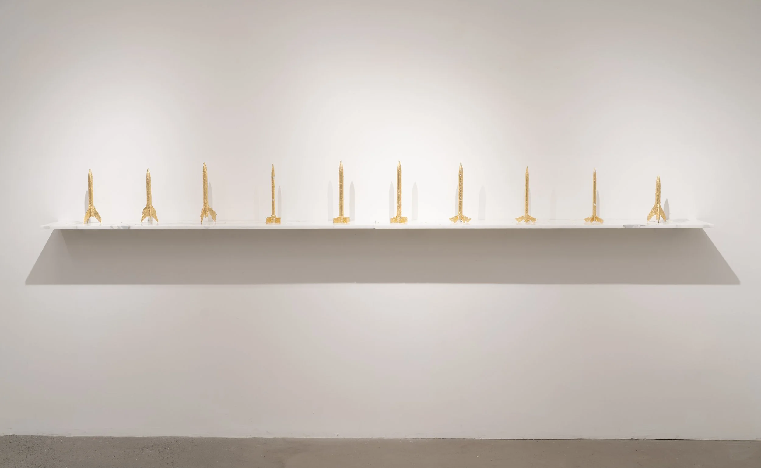 Glare, 2025 (14.75 x 14 x 10" in.) Model rockets, 24K gold foil, Carrara marble.
